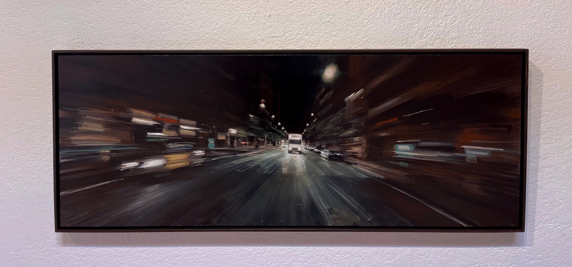 A painting of a city street at night with cars driving down it.