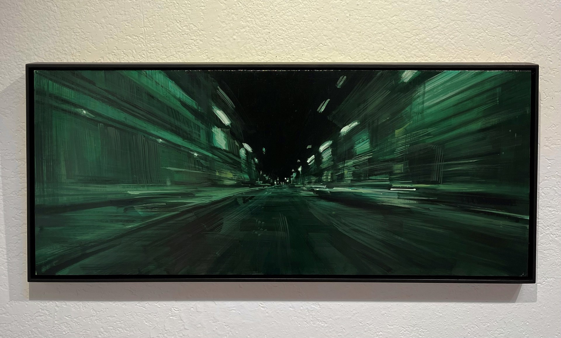 A first-person perspective of a rapid journey through a dark, green-lit urban corridor.