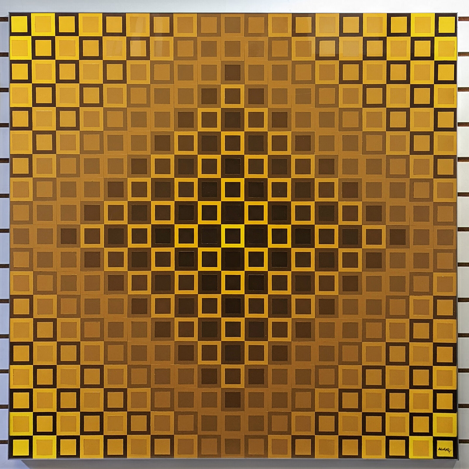 A geometric grid of squares forming a face using yellow and brown tones.