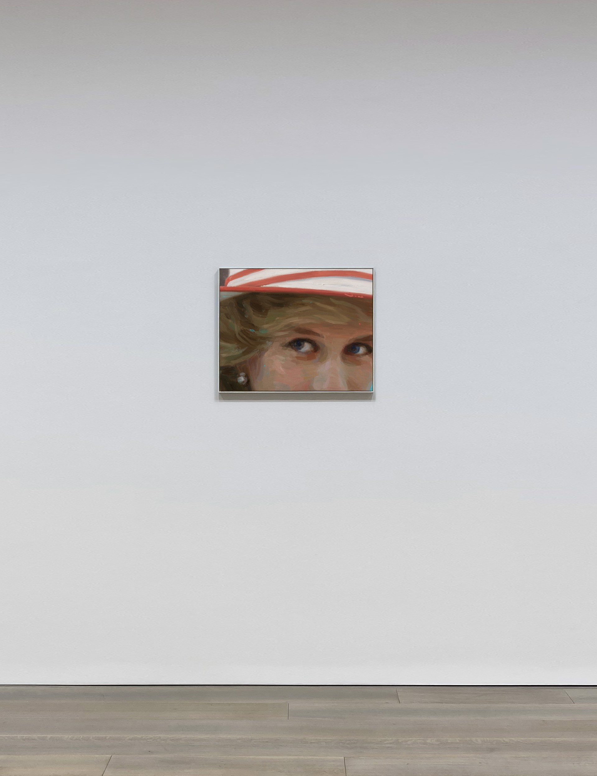 A close-up portrait of a figure wearing a red and white hat, focusing on expressive eyes.
