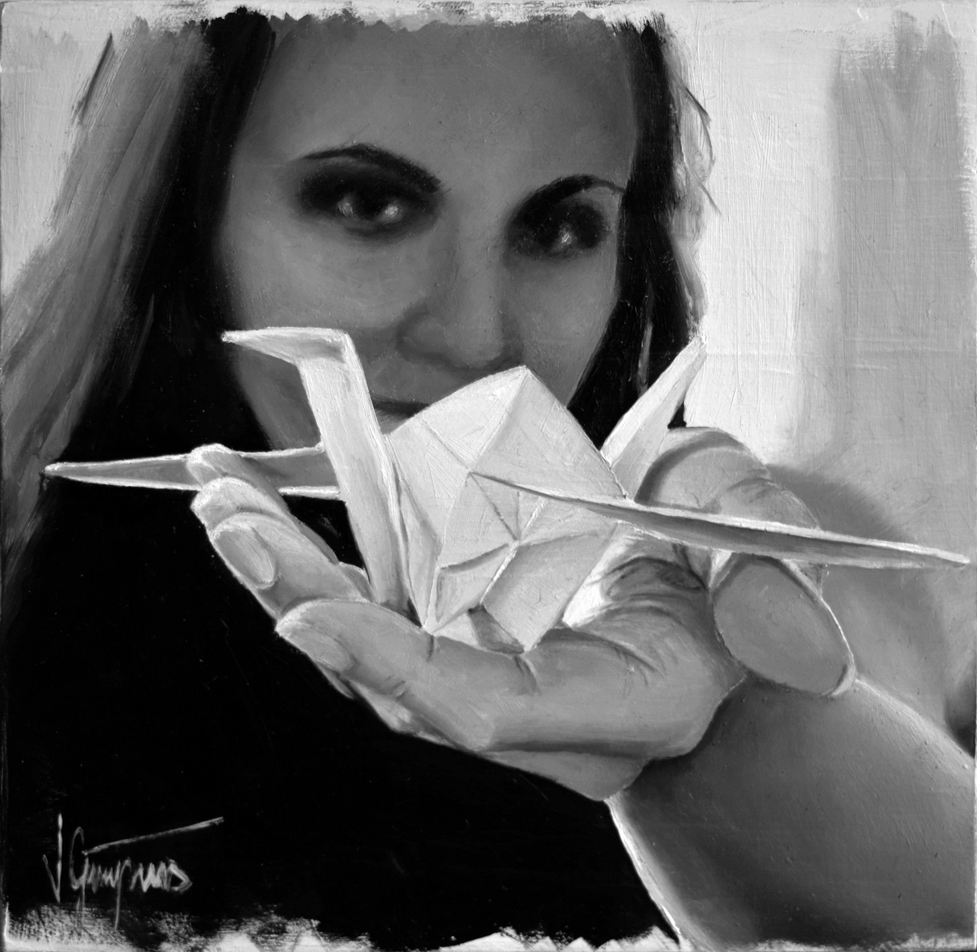 A black and white photo of a woman holding a paper airplane.