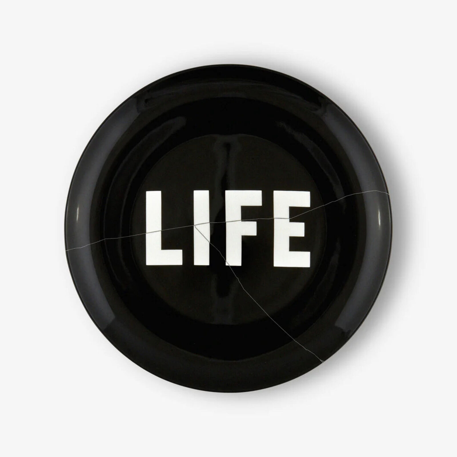 A black plate with the word LIFE written on it.