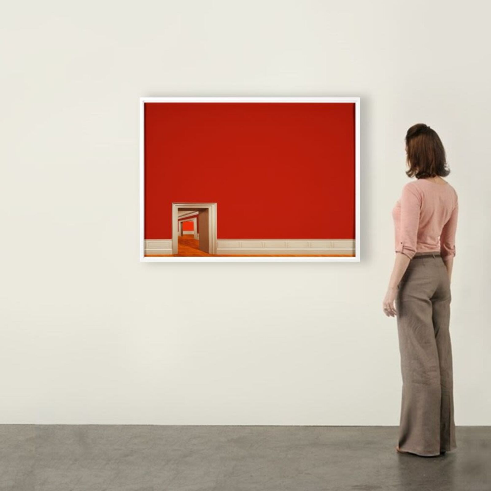 A minimalist interior scene featuring a red wall, white trim, and a series of doorways leading into an empty hallway.