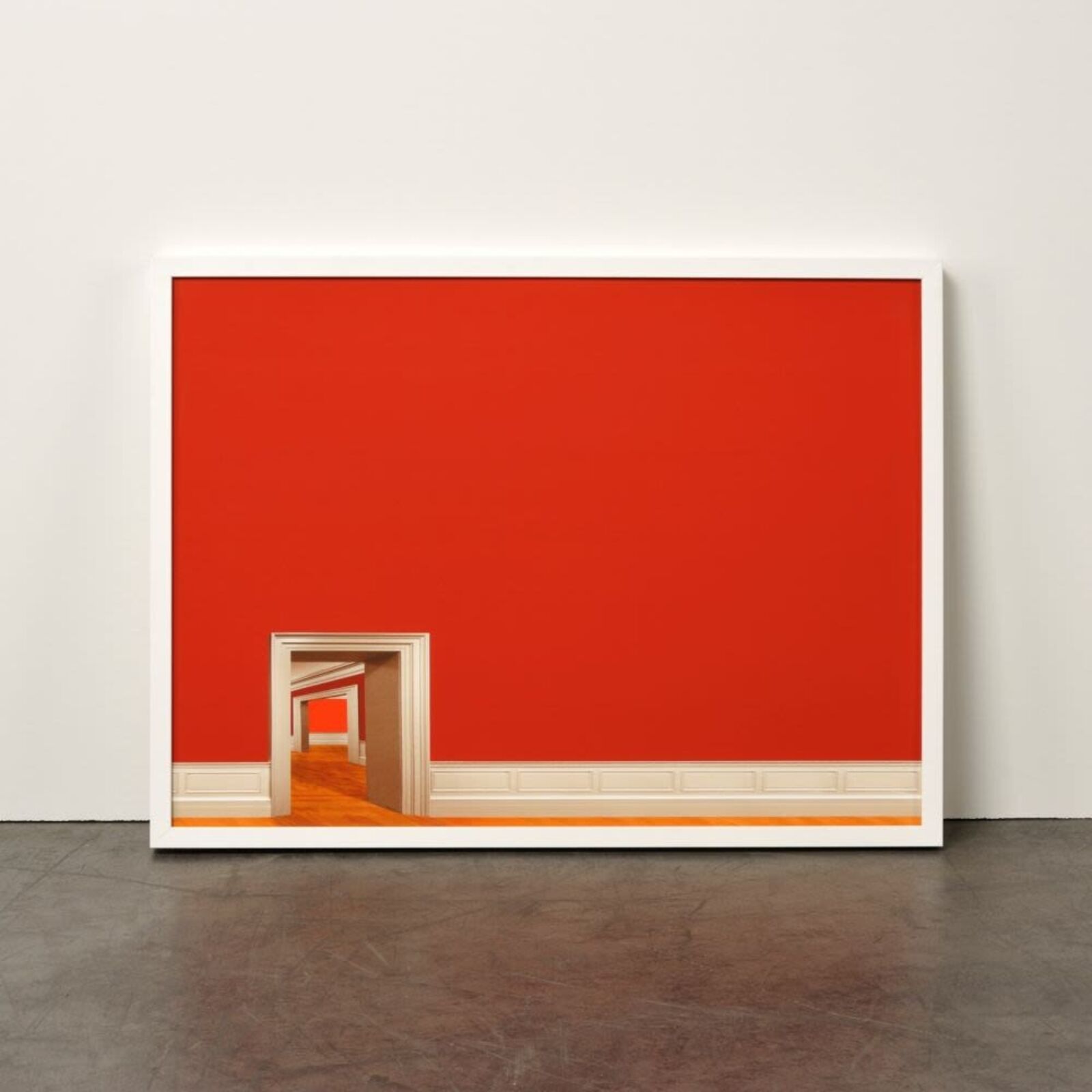 A minimalist interior scene featuring a red wall, white trim, and a series of doorways leading into an empty hallway.