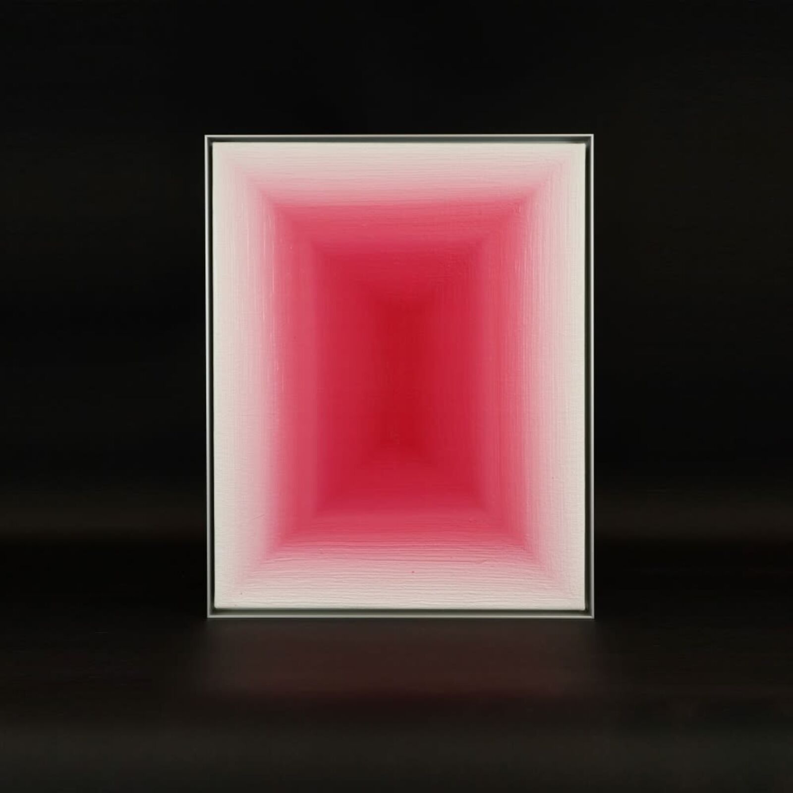 A pink room with a vase and a picture on the wall.