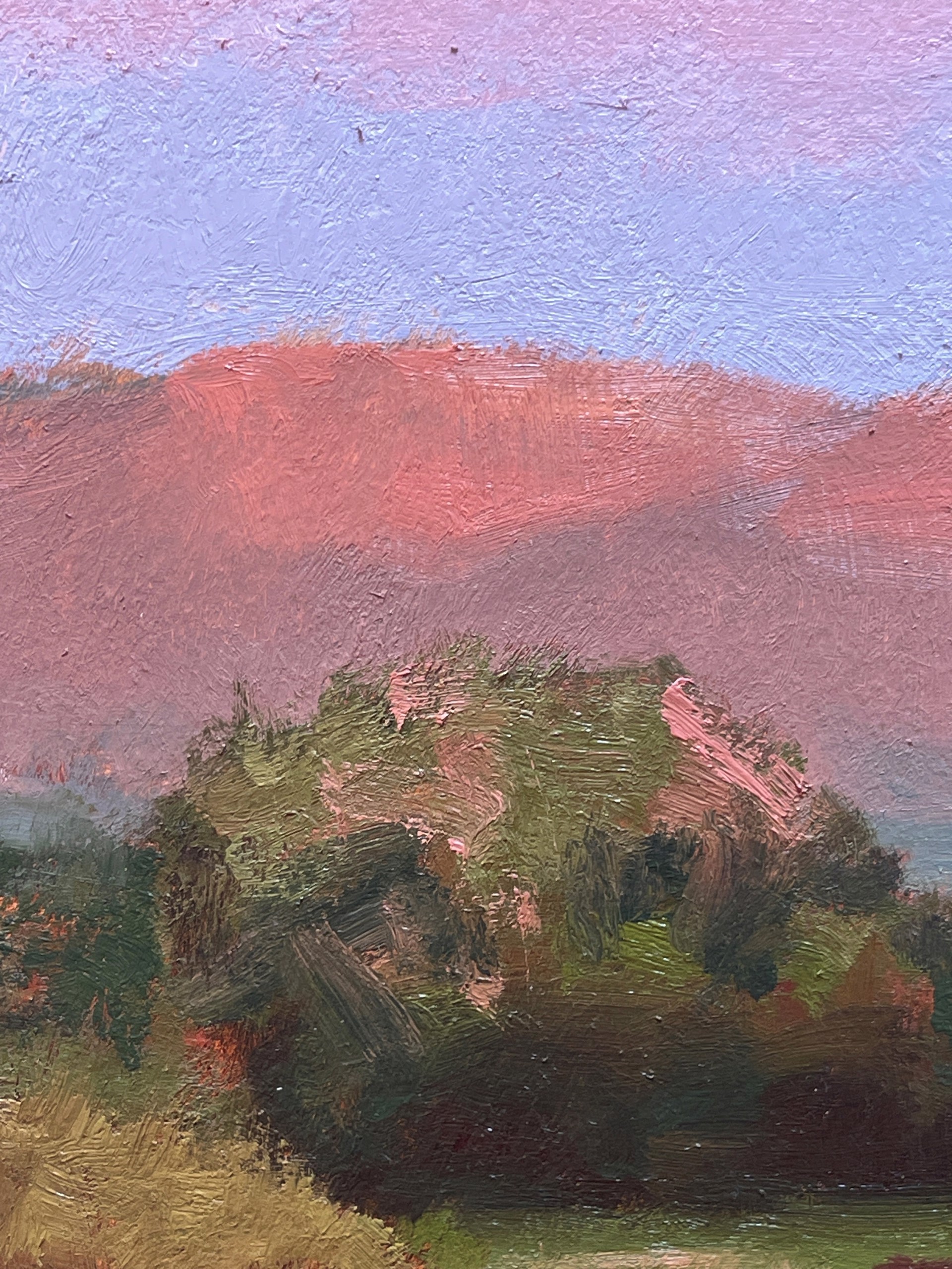 A serene landscape painting featuring a winding stream, green meadow, and dramatic pink clouds over distant hills.