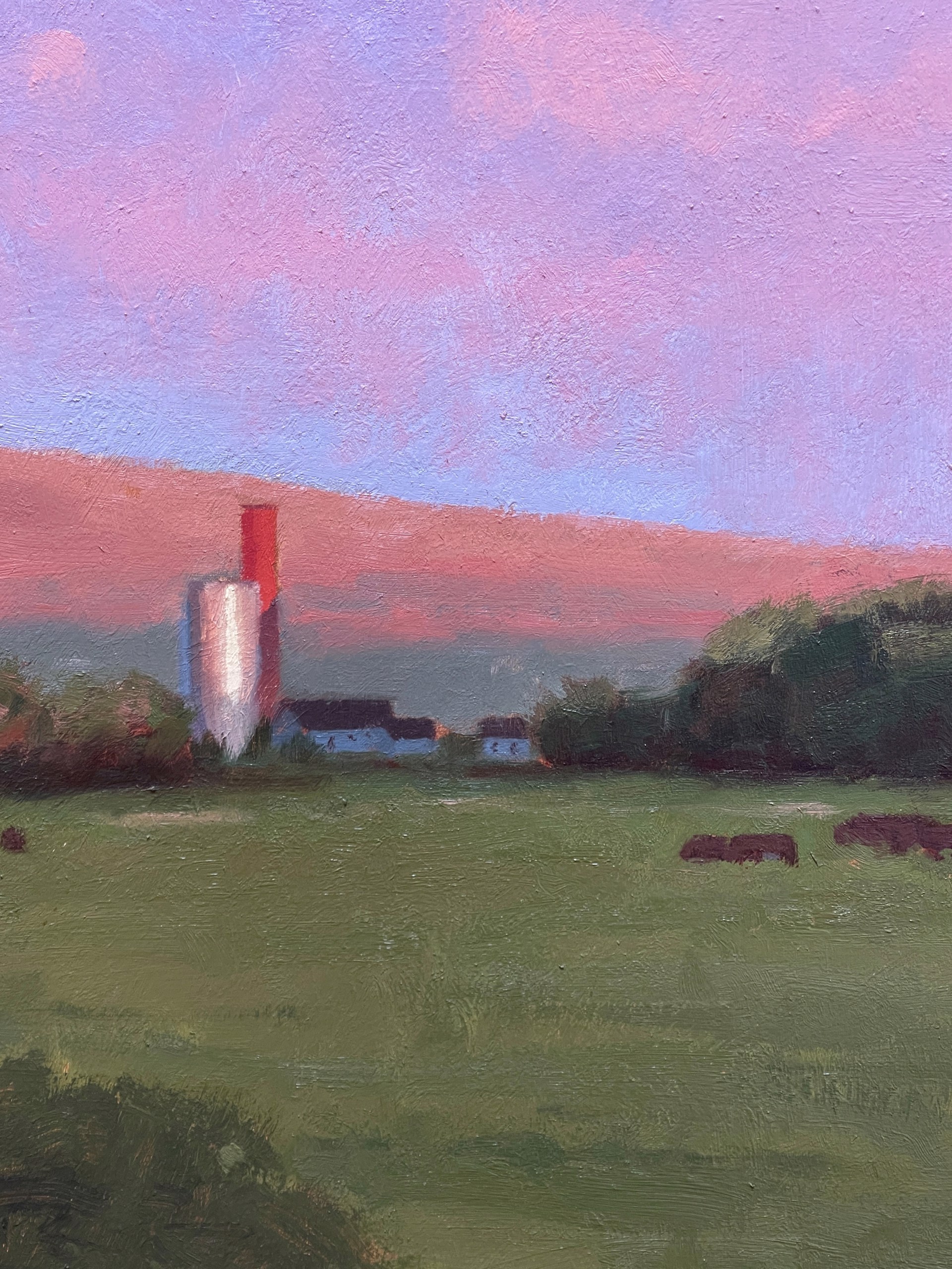 A serene landscape painting featuring a winding stream, green meadow, and dramatic pink clouds over distant hills.