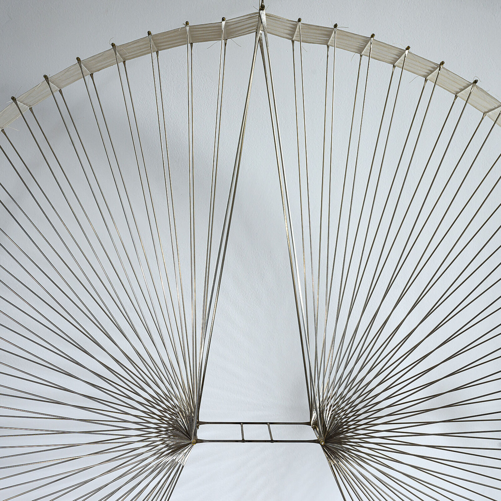 A large metal sculpture hanging from the ceiling in a room.