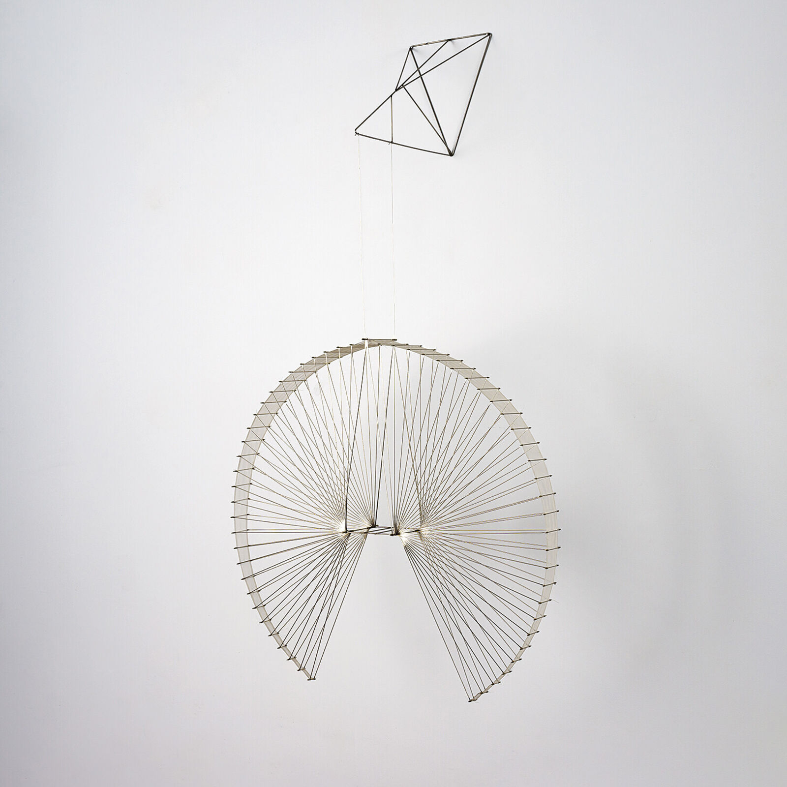 A large metal sculpture hanging from the ceiling in a room.