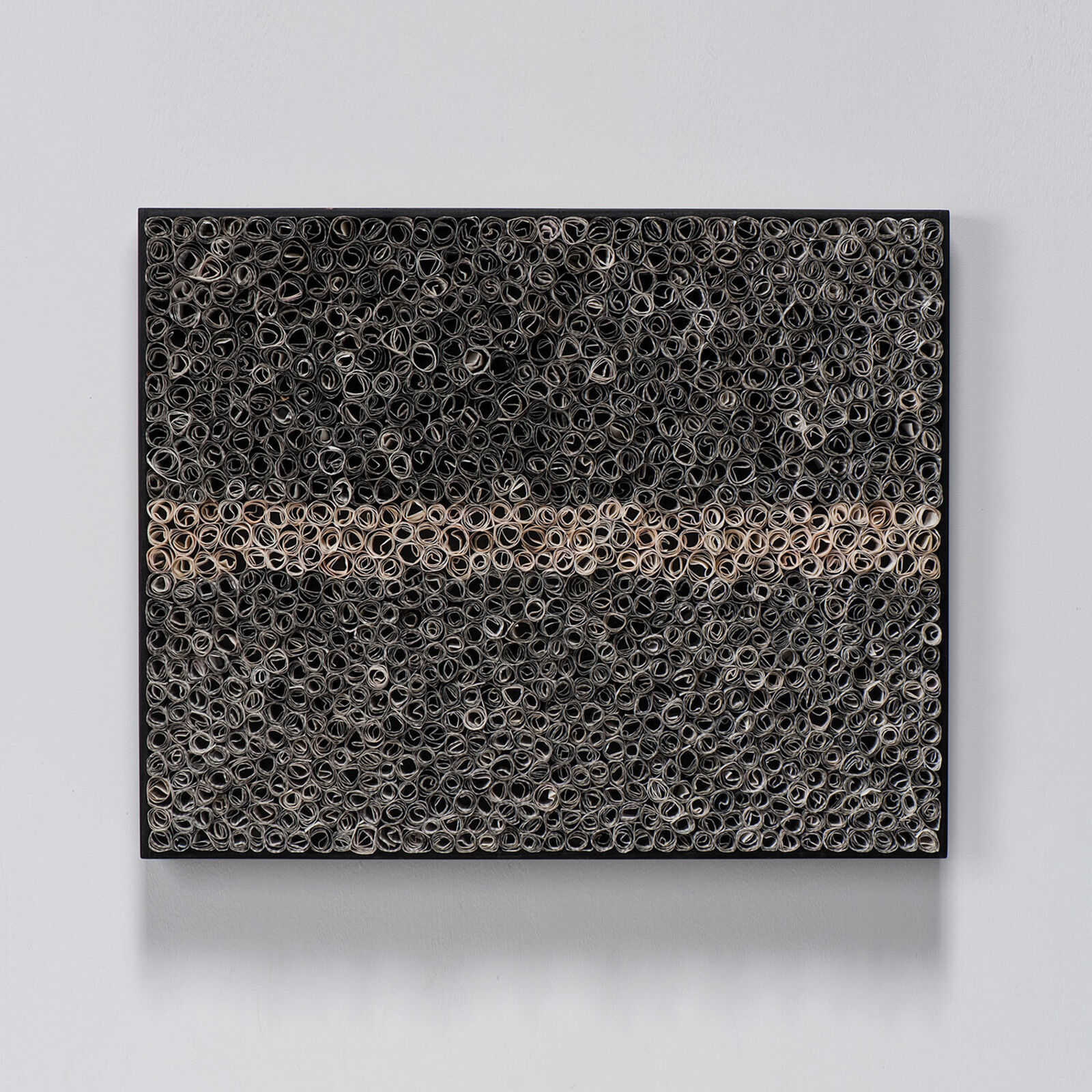 A textured rectangular artwork composed of thousands of small rolled paper tubes arranged in a dense, layered pattern.