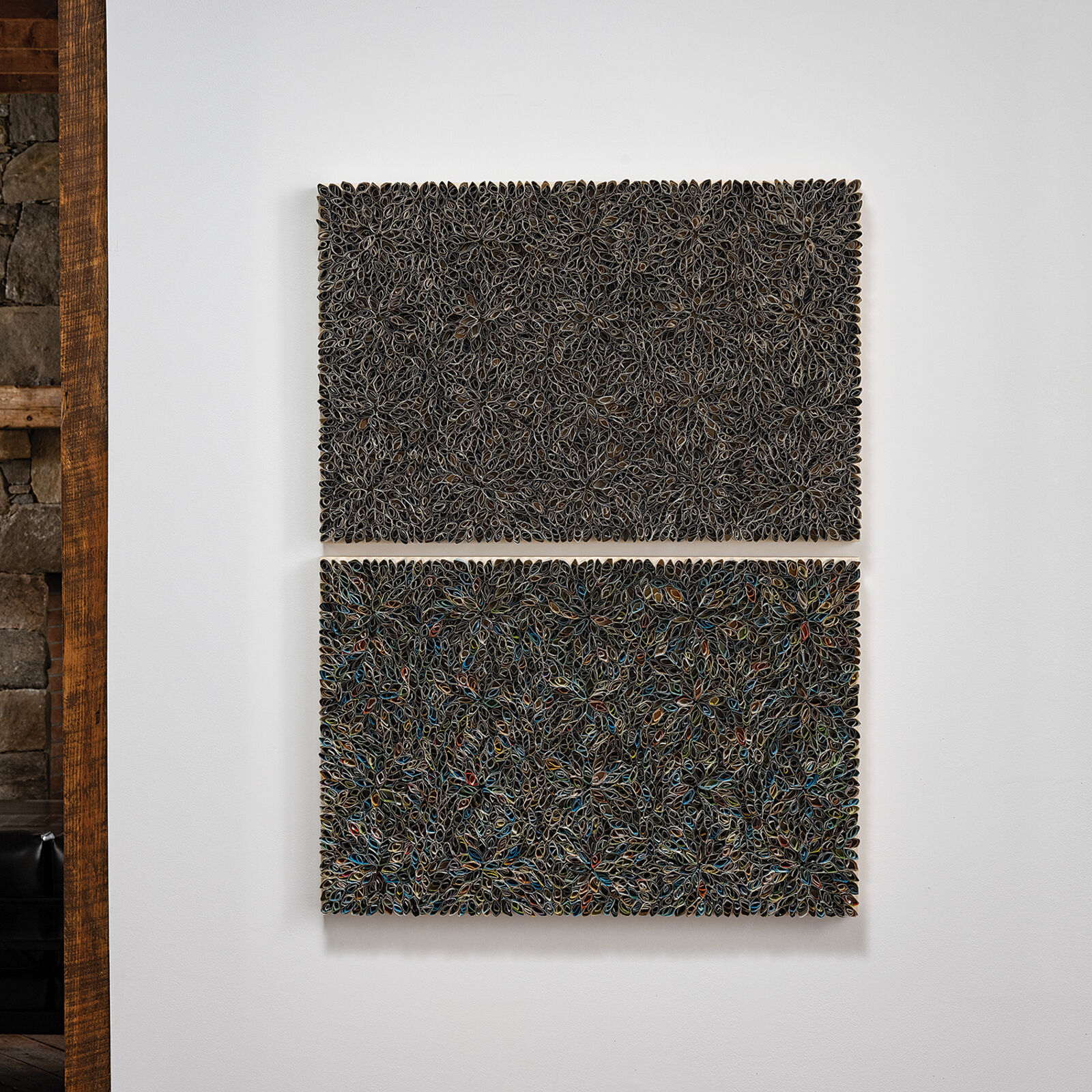 A diptych of textured, floral-patterned panels mounted on a white wall.