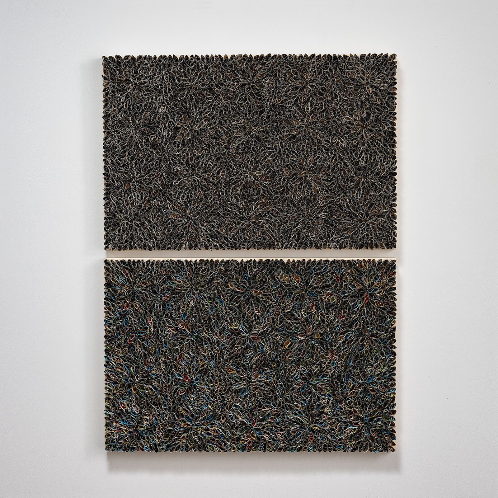 A diptych of textured, floral-patterned panels mounted on a white wall.