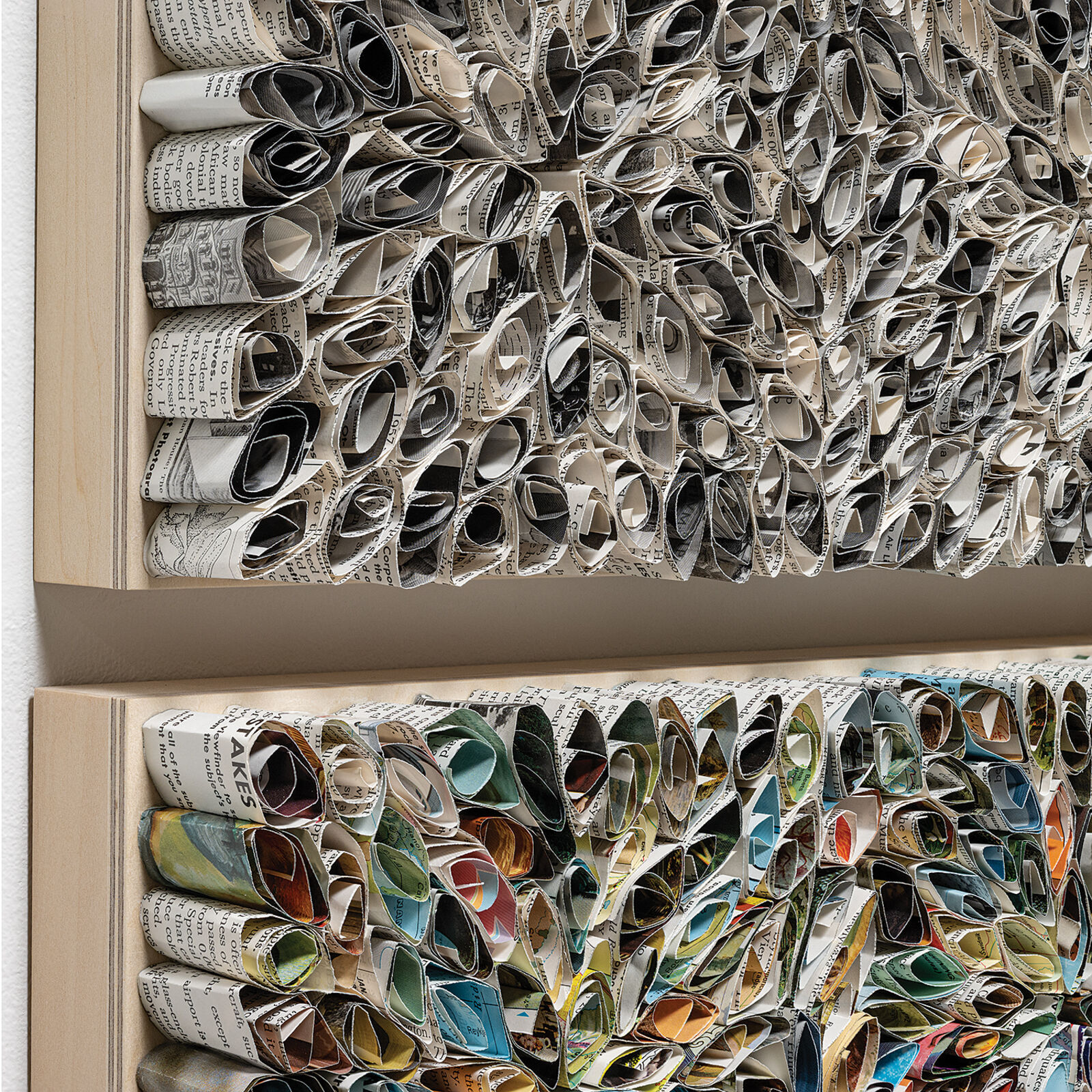 A diptych of textured, floral-patterned panels mounted on a white wall.