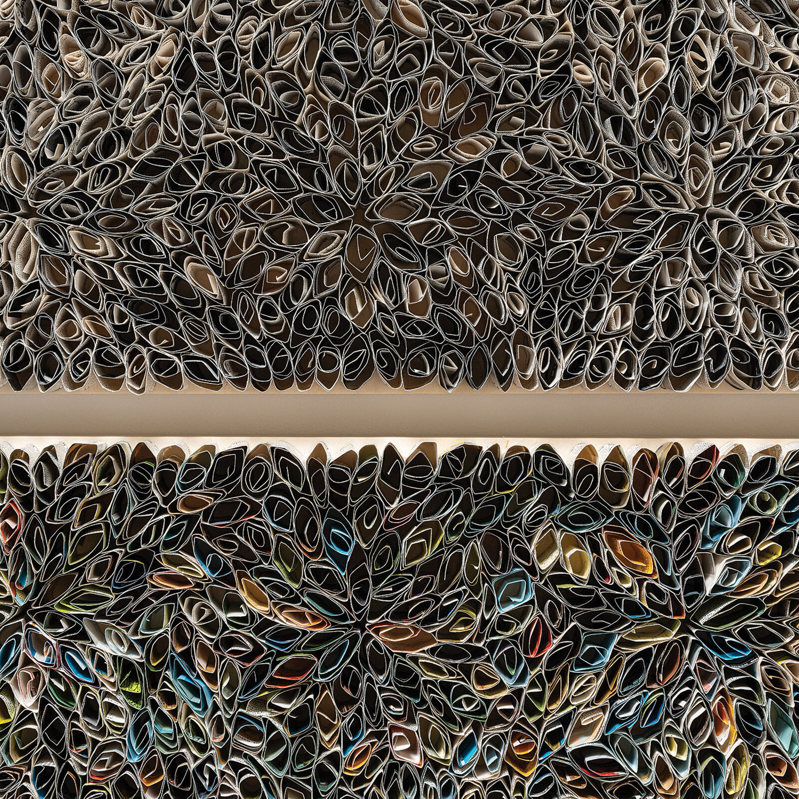 A diptych of textured, floral-patterned panels mounted on a white wall.