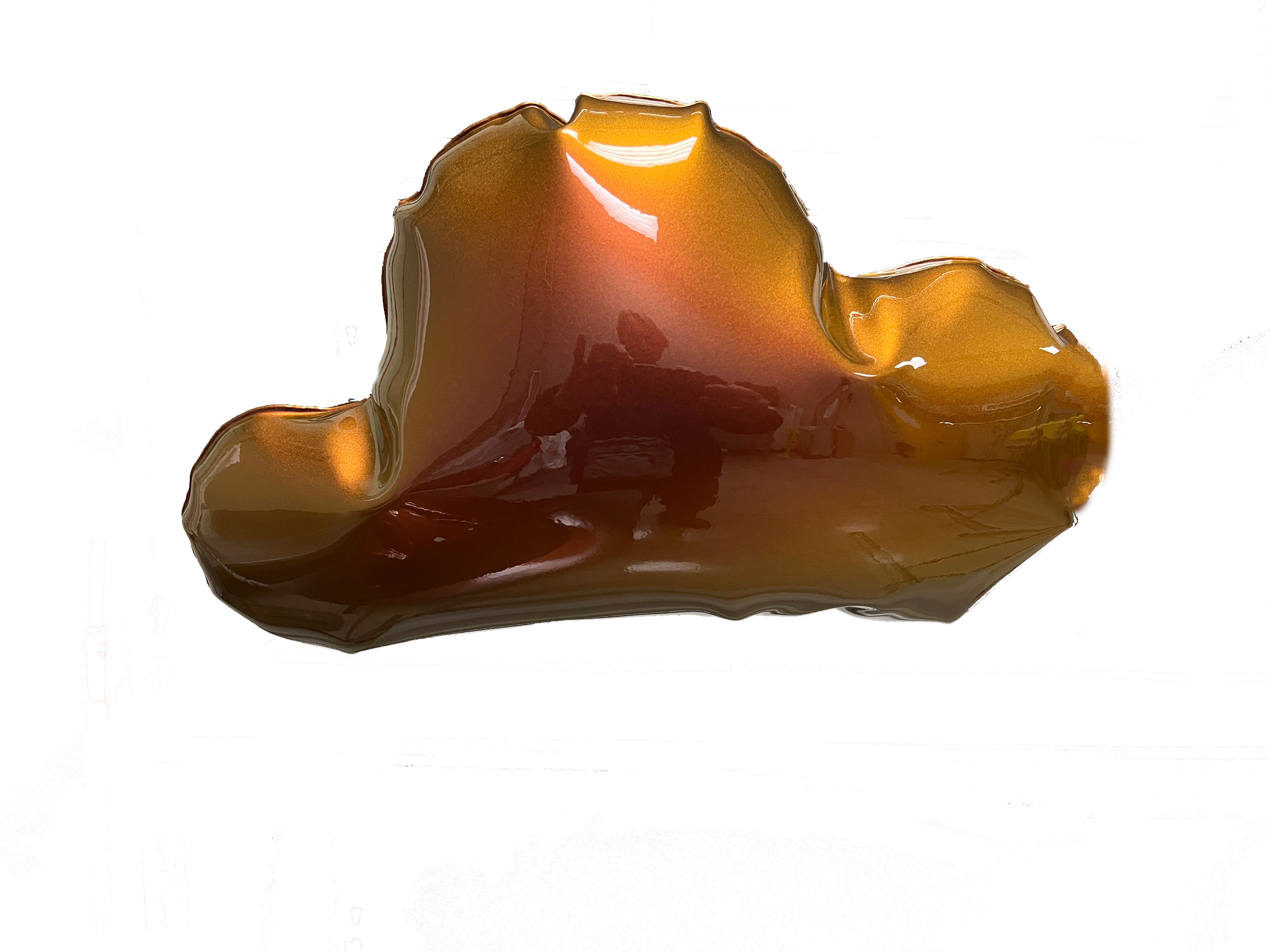 A piece of amber glass on a white surface.