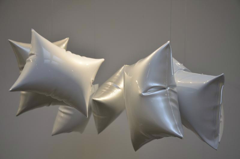 A group of white stars hanging from a ceiling.