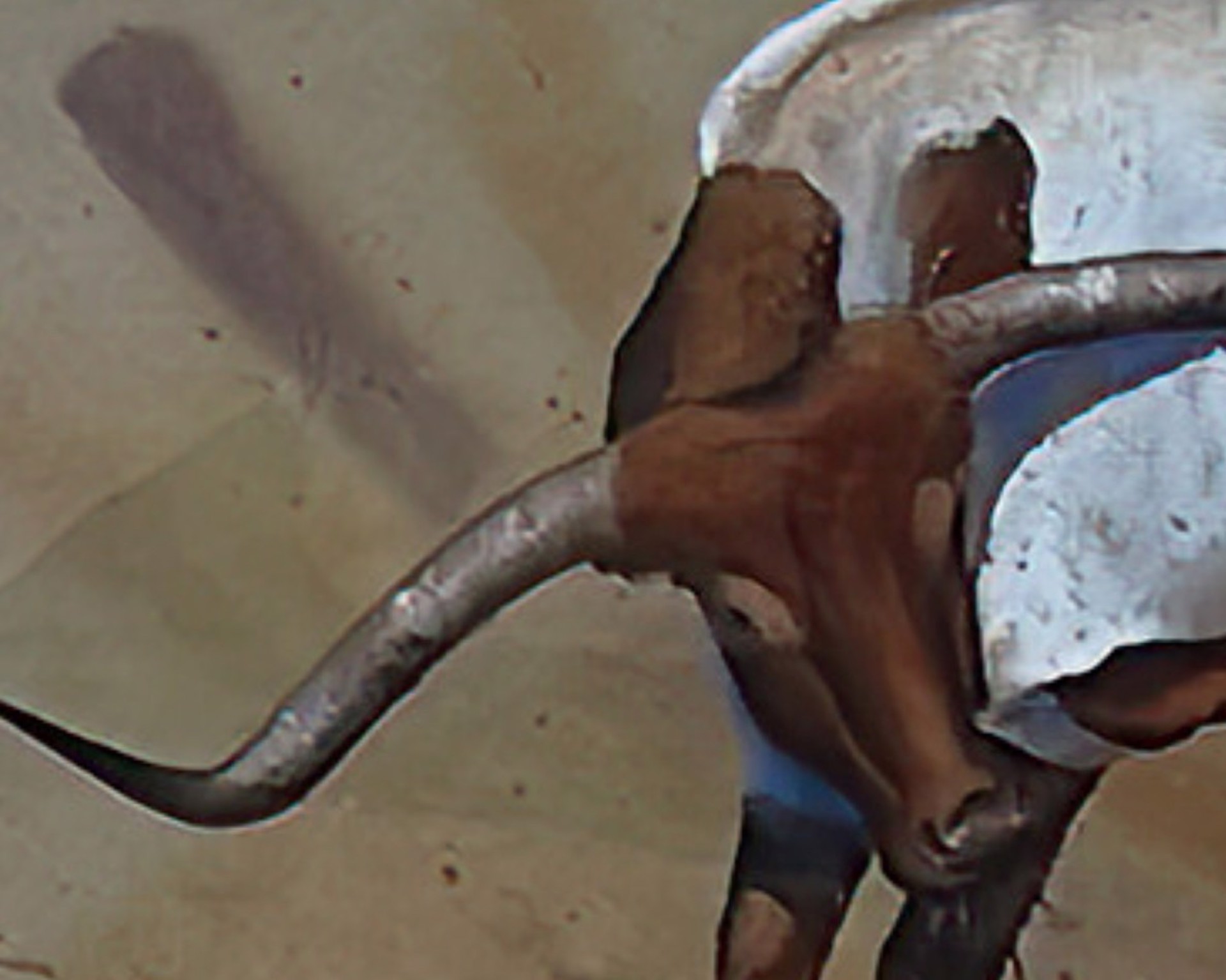 A stylized painting of a white bull with long curved horns standing in a desert landscape.