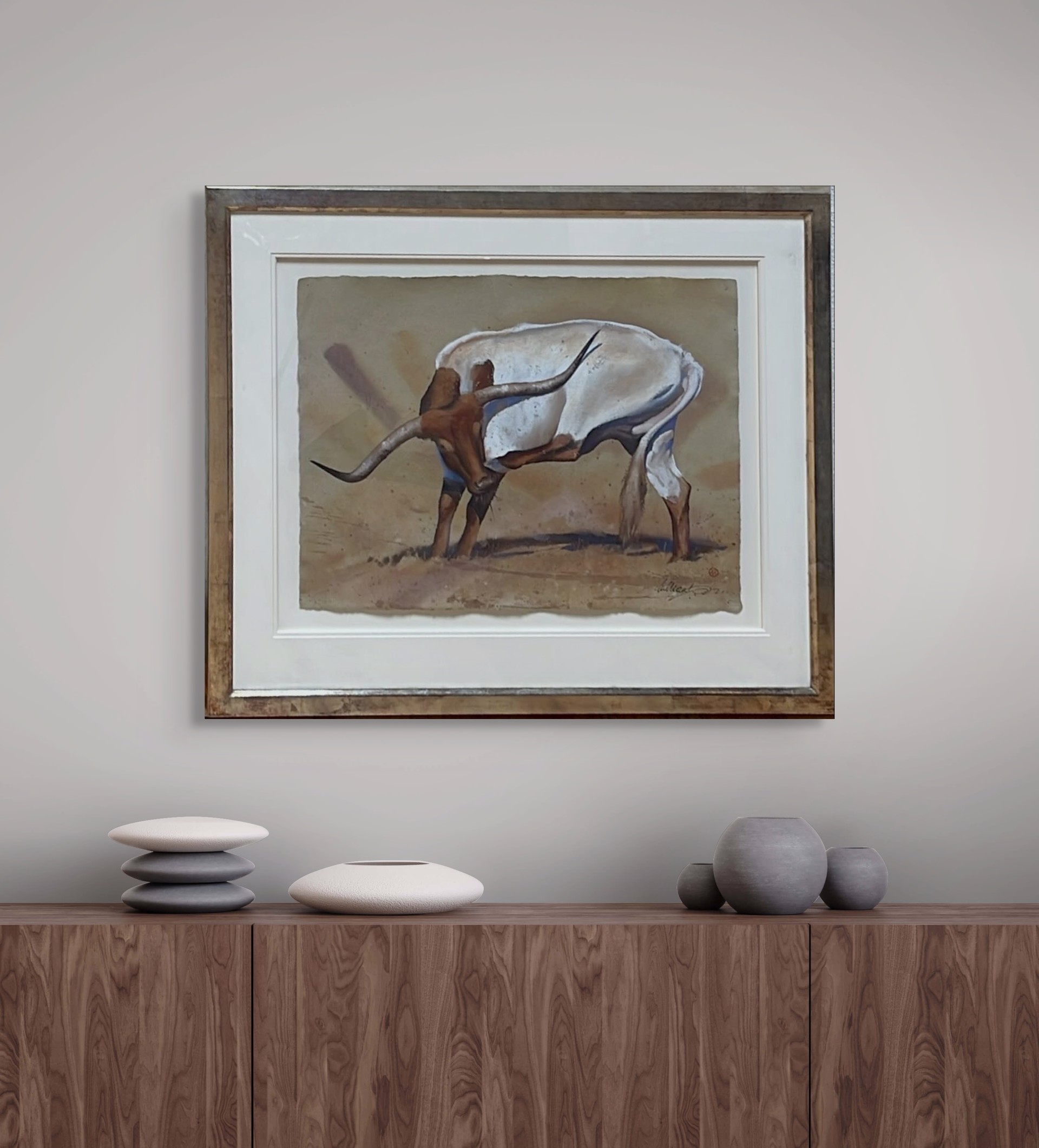 A stylized painting of a white bull with long curved horns standing in a desert landscape.