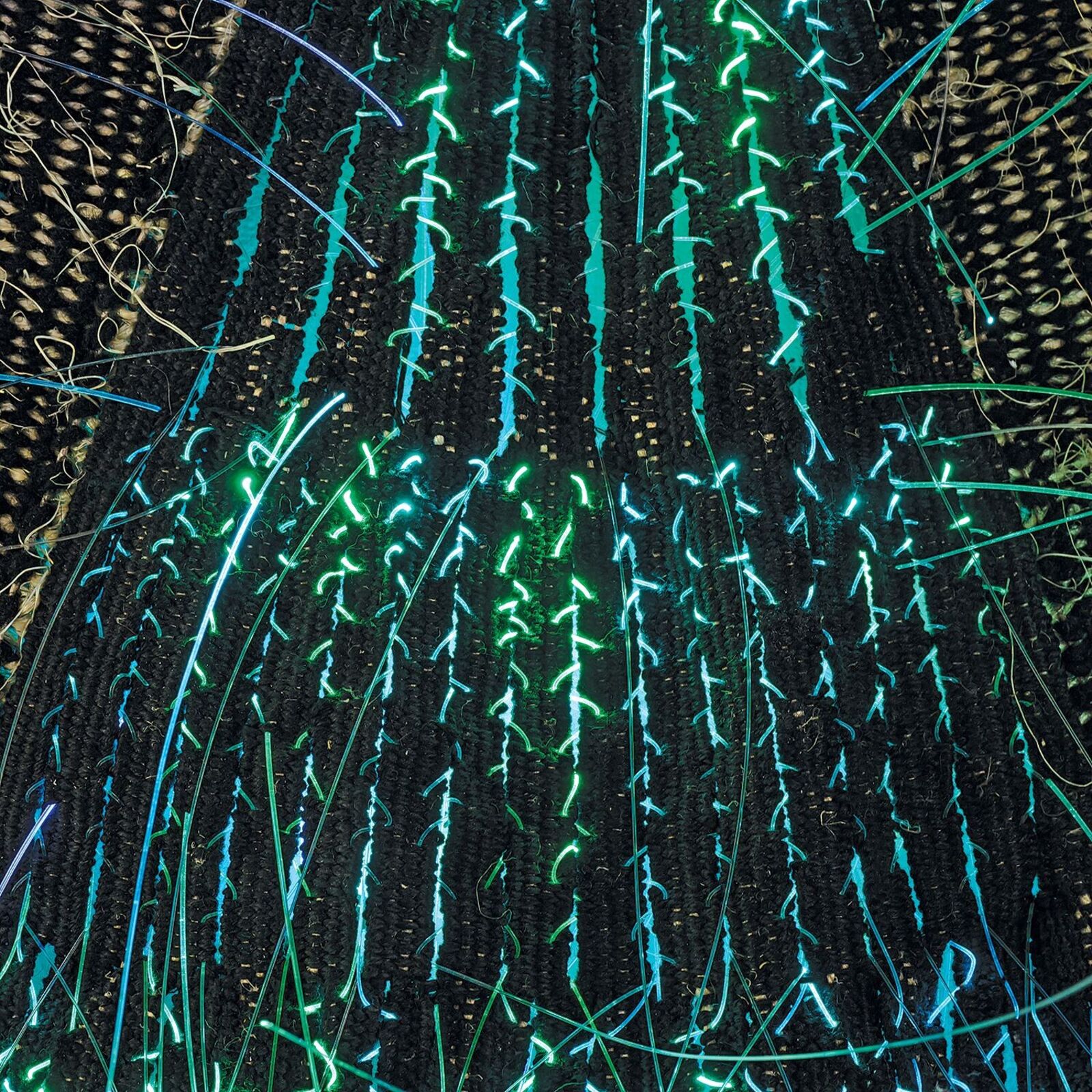 A woven textile artwork featuring three triangular shapes with embedded lights.