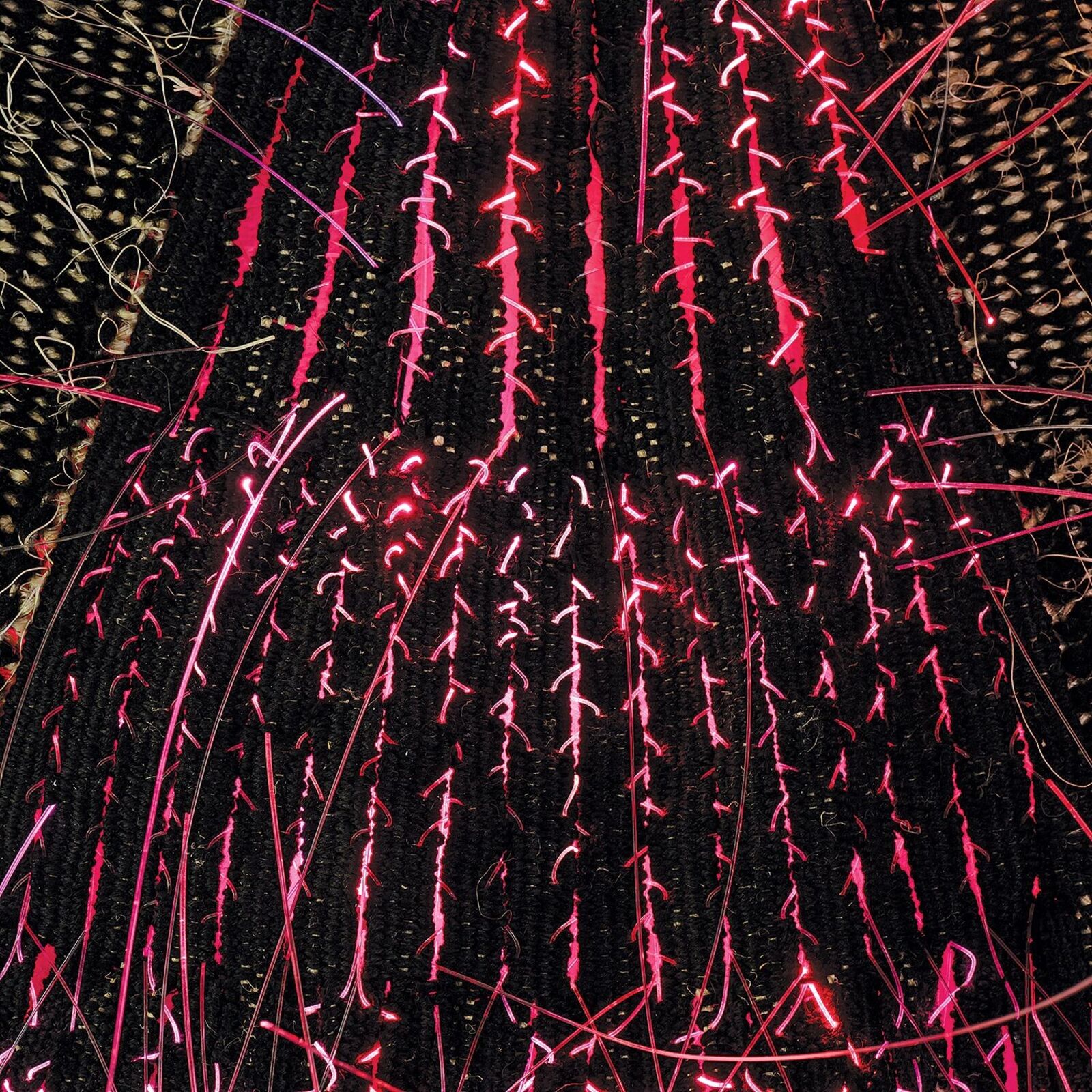 A woven textile artwork featuring three triangular shapes with embedded lights.