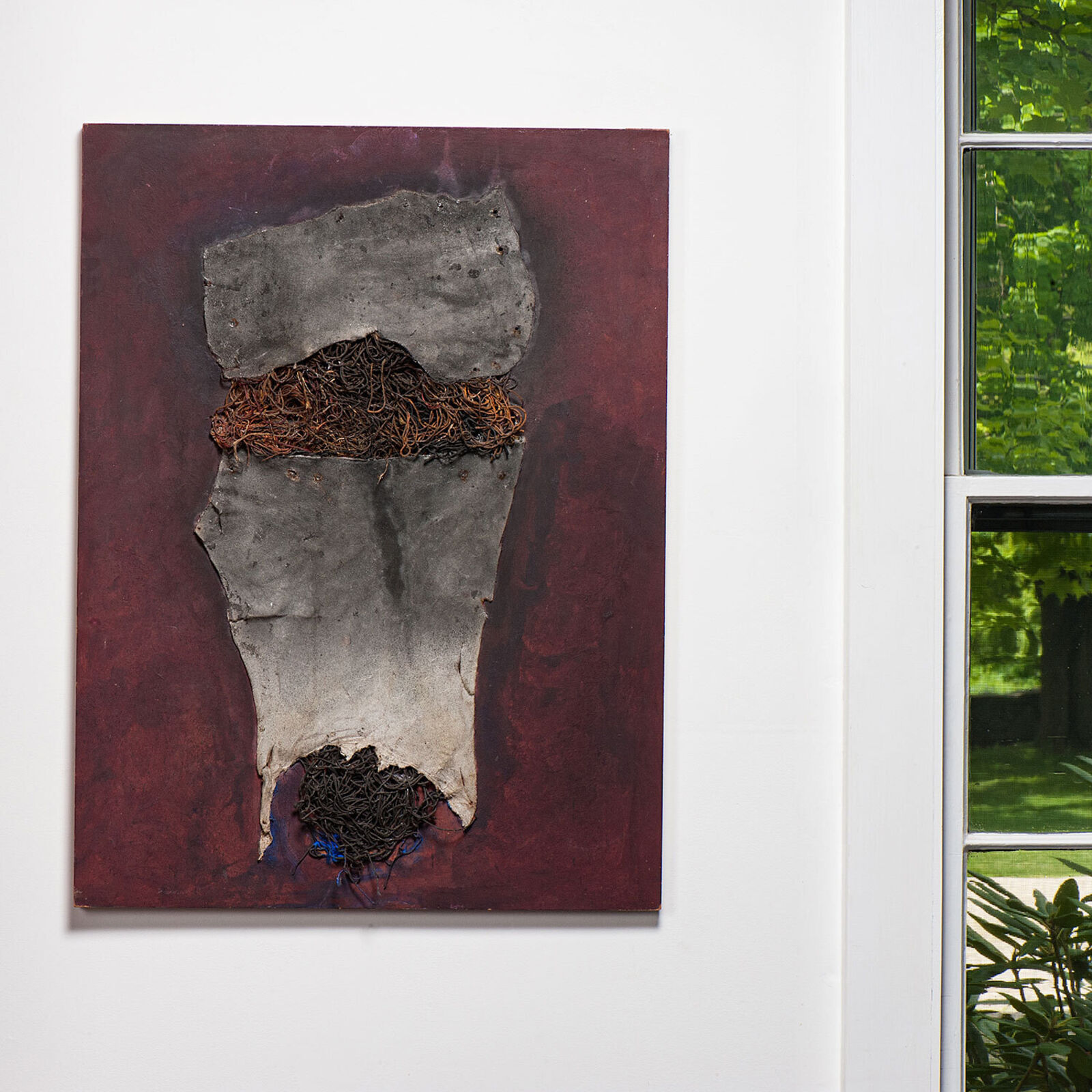 A painting hanging on a wall in a room.