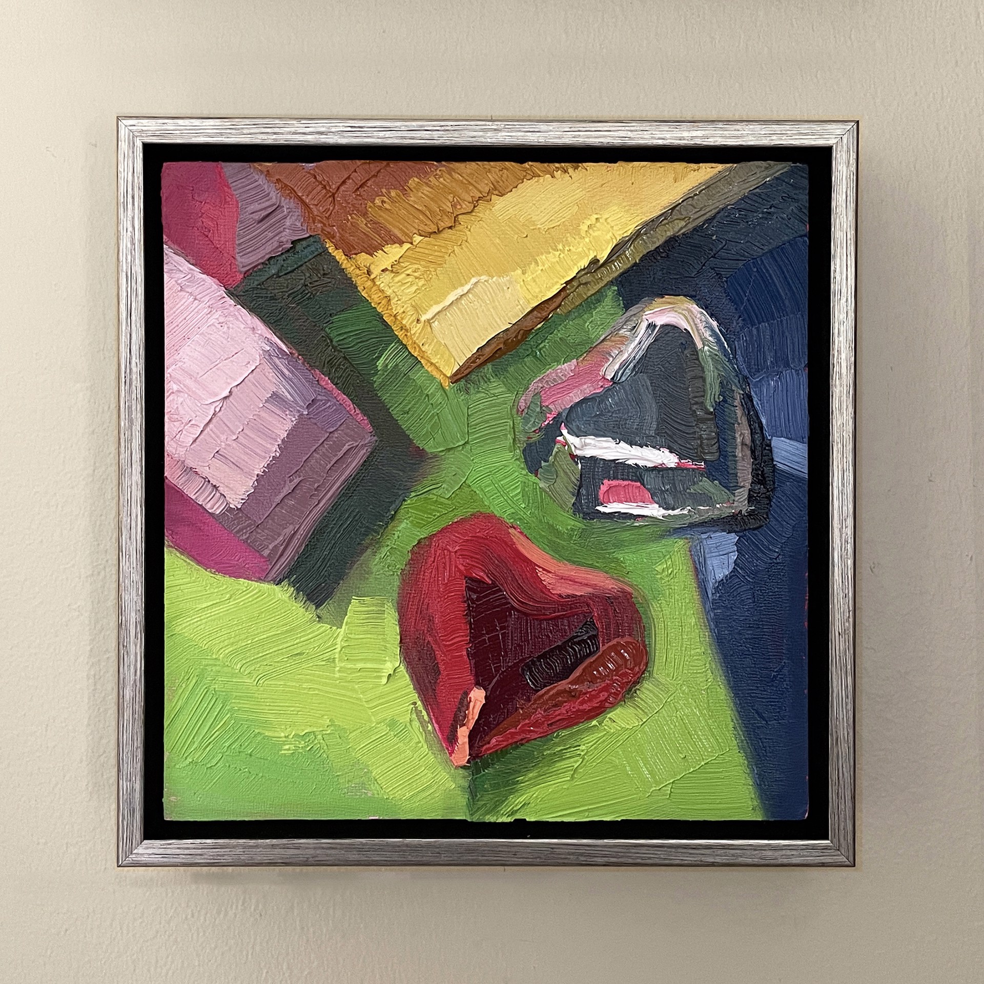 A painting of a red heart on a green background.