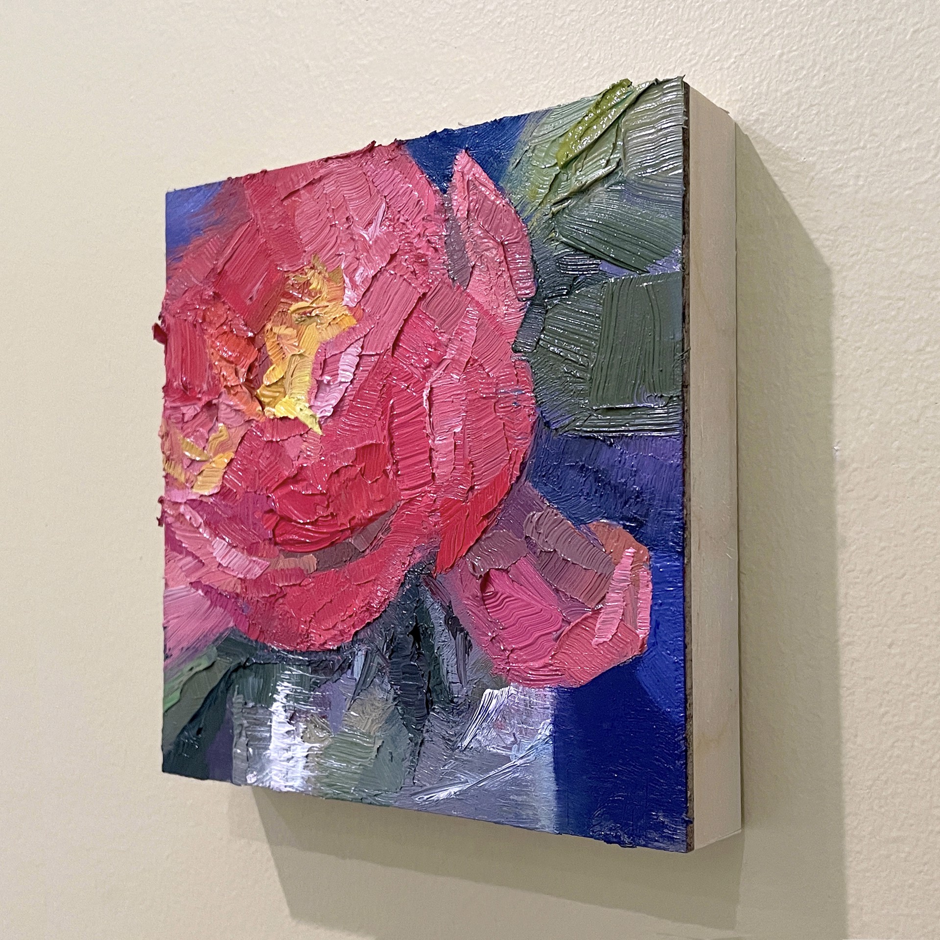 A painting of a red flower on a blue background.