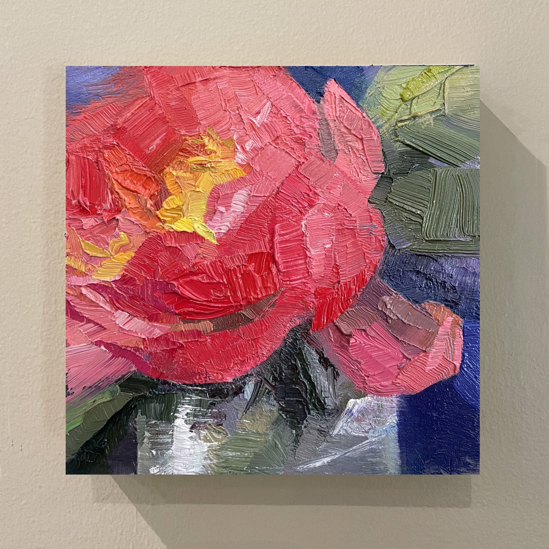 A painting of a red flower on a blue background.