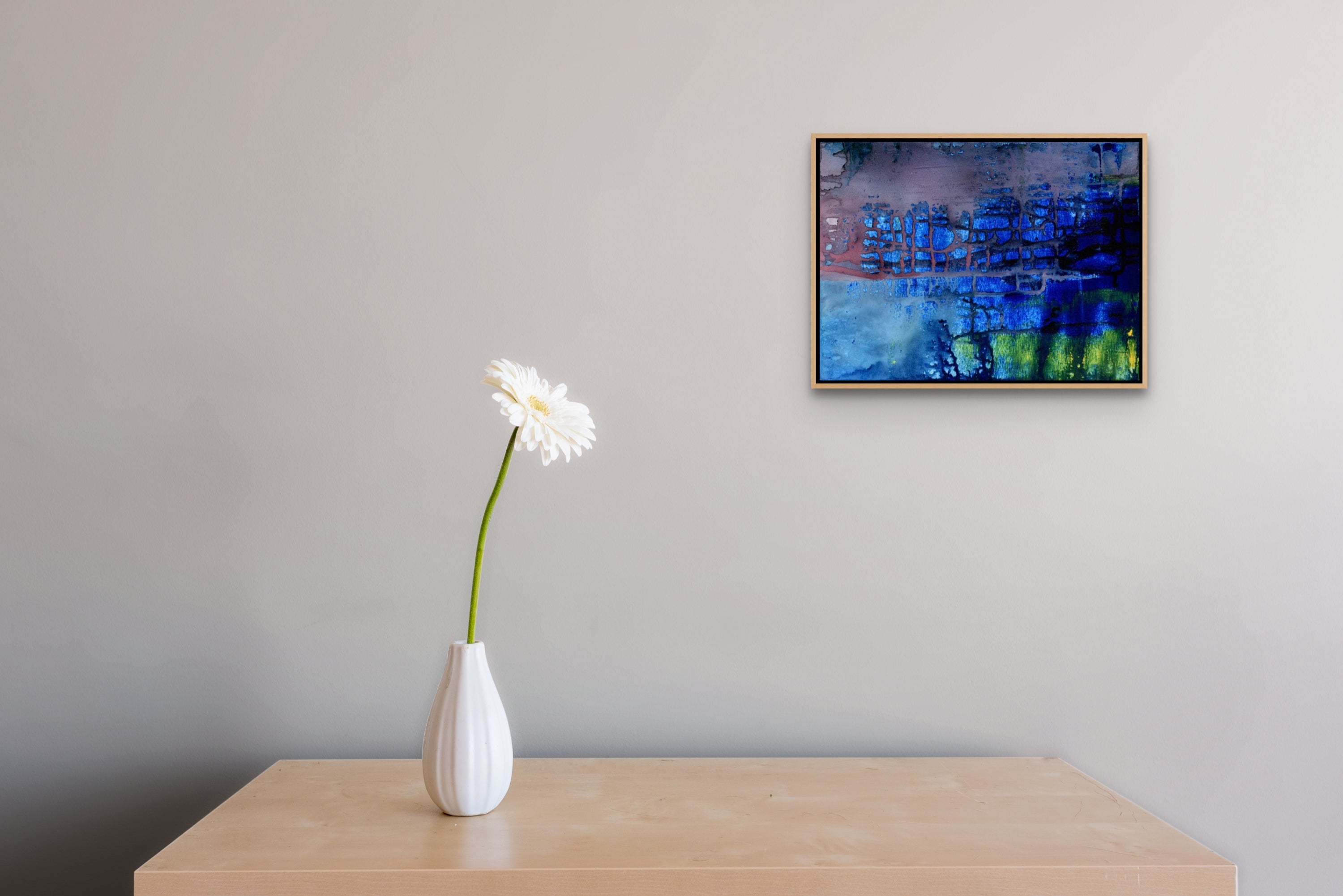 A painting of a blue and green abstract painting on a wall.