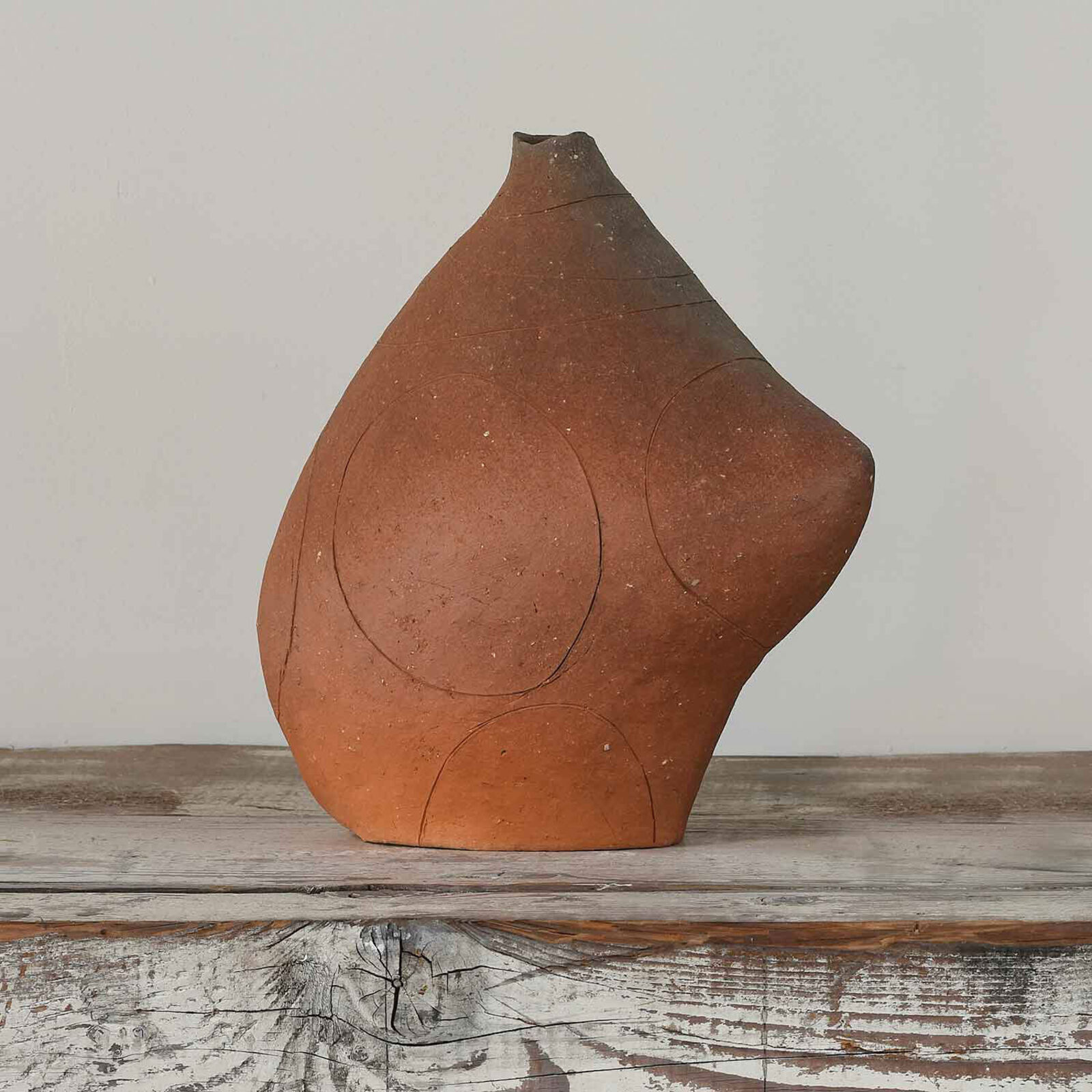 A couple of vases sitting on top of a wooden shelf.