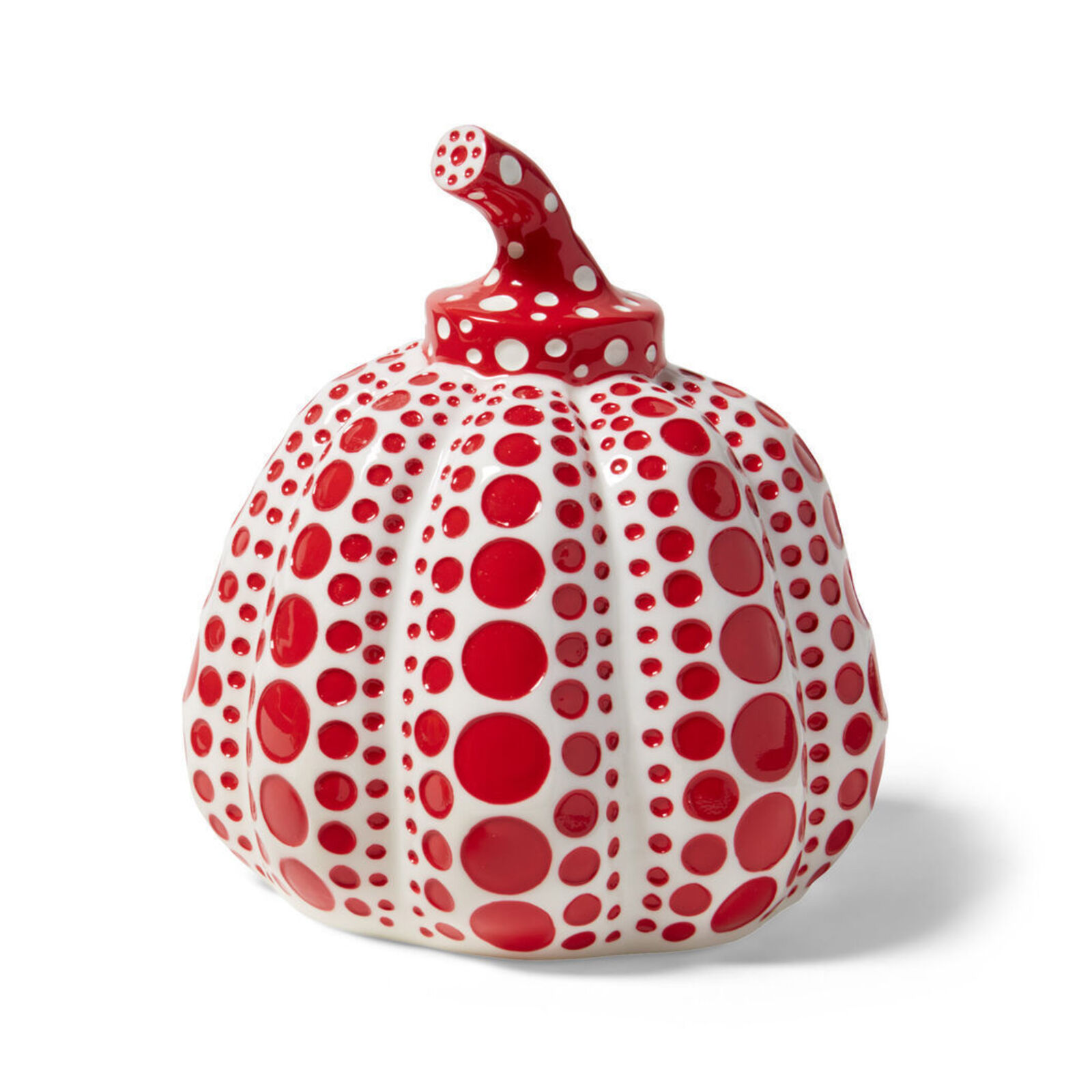 A red and white polka dot pumpkin on a white background.