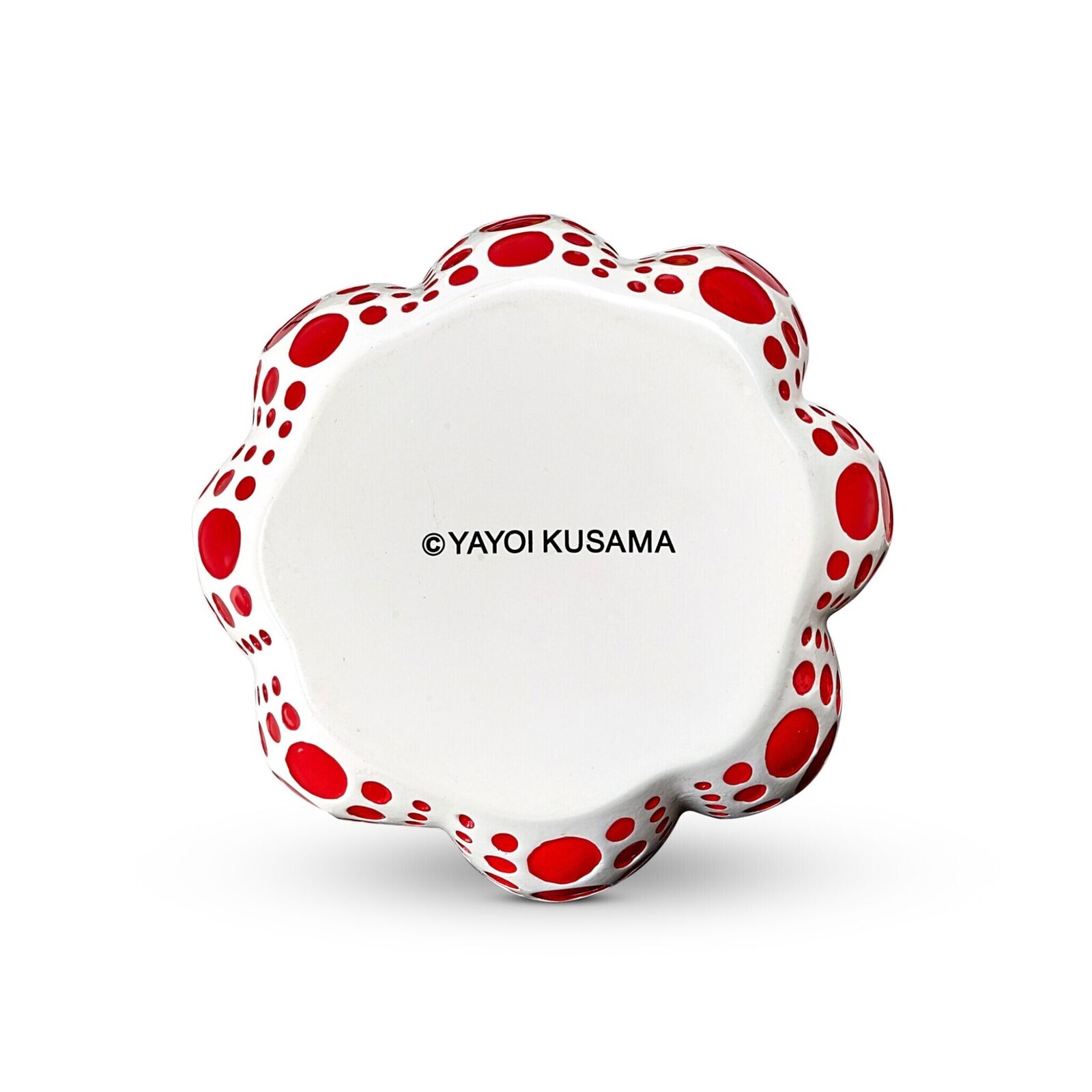 A red and white polka dot pumpkin on a white background.