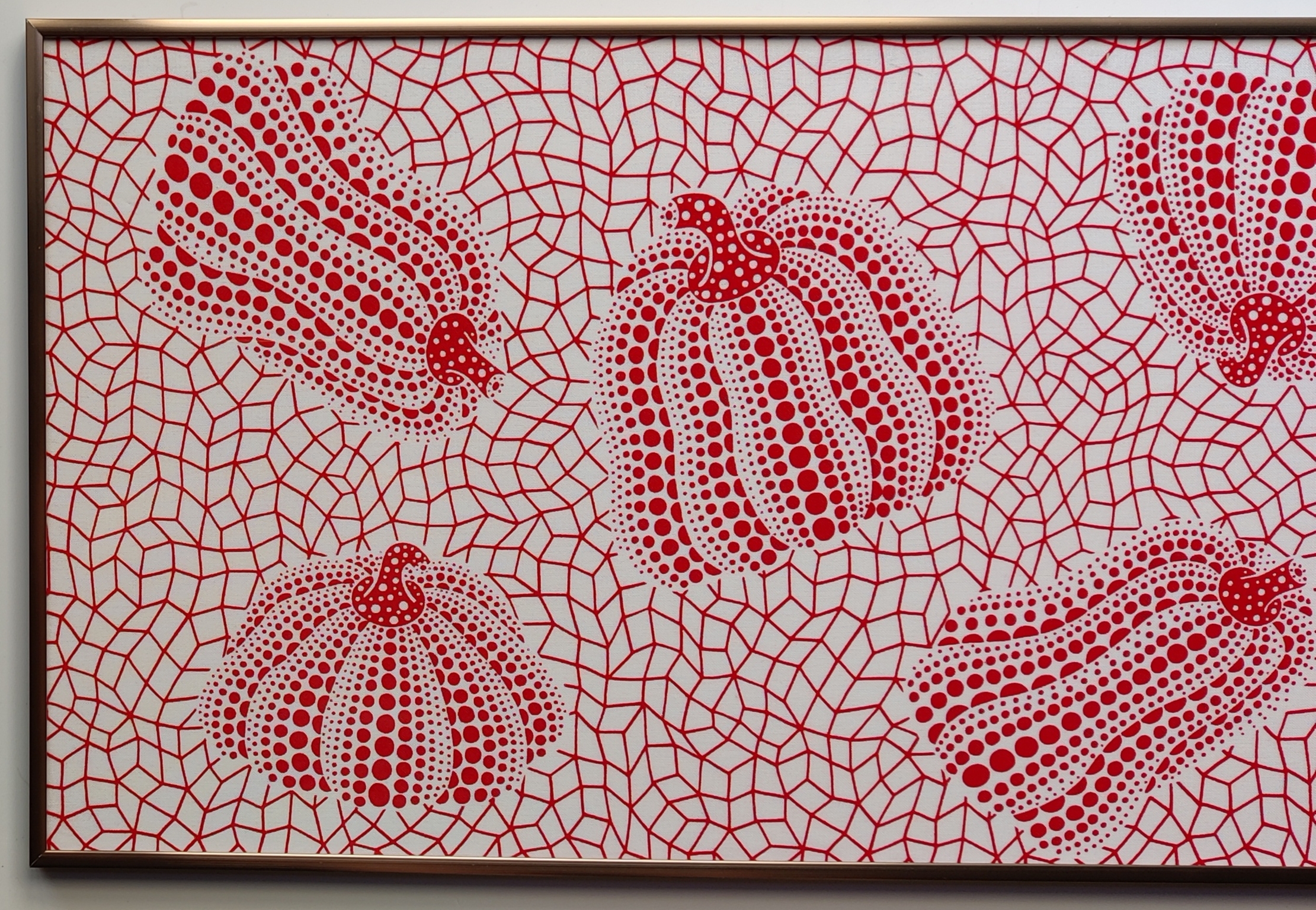 A red and white painting on a white wall.