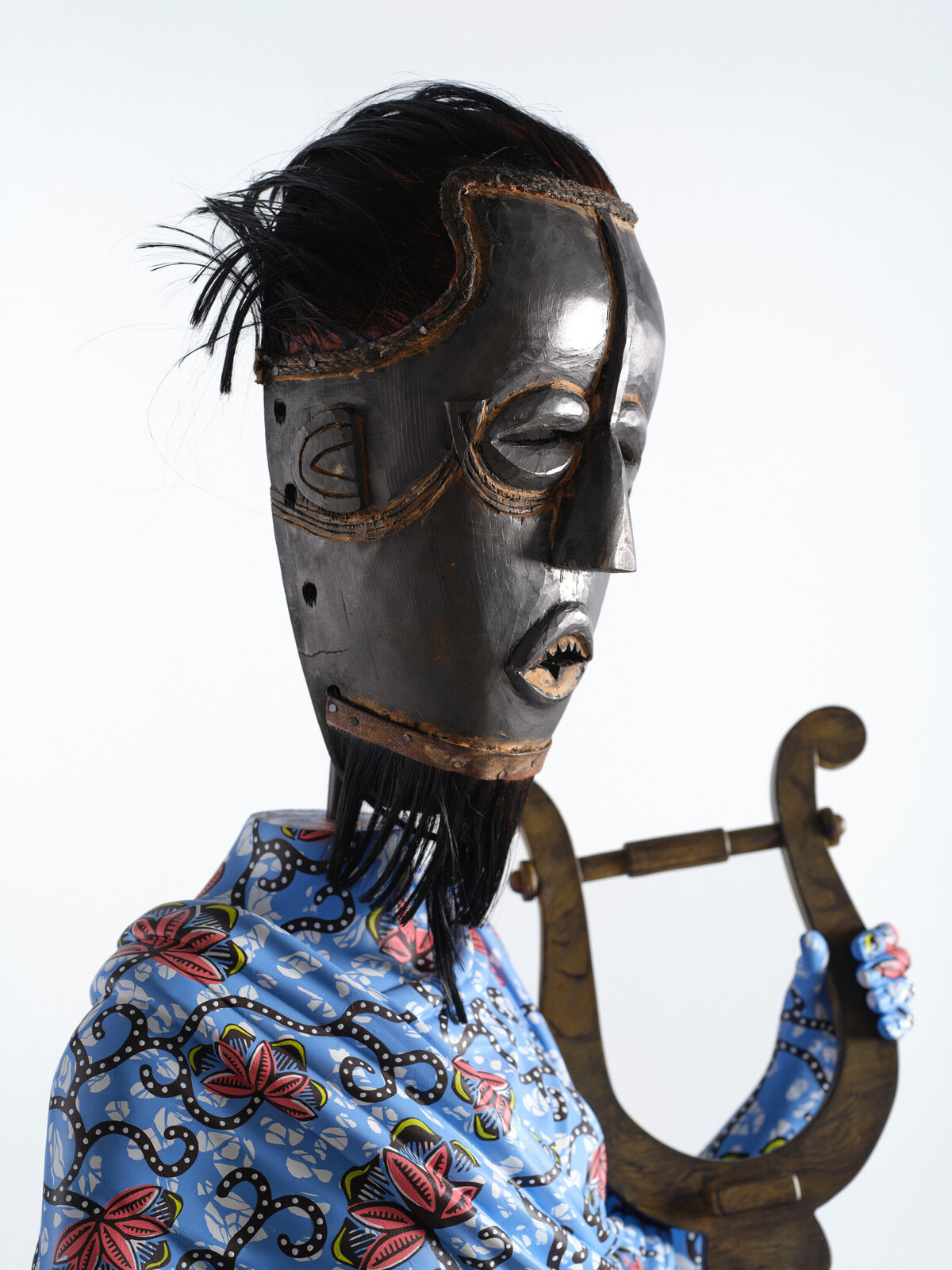 Artwork by Yinka Shonibare, Hybrid Sculpture (Terpsichore / Bété-Guro Mask), Made of Fibreglass sculpture, hand-painted with Dutch wax pattern, hand-carved wooden mask and steel baseplate or plinth 