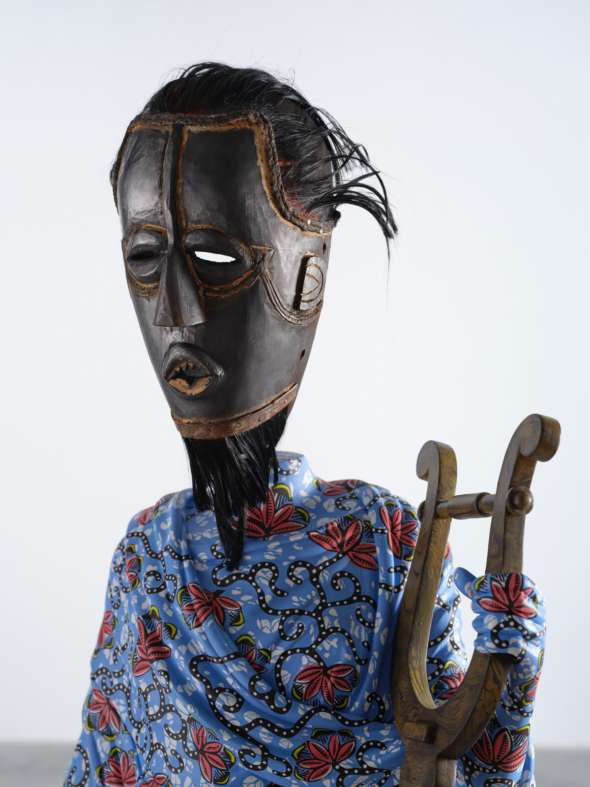 Artwork by Yinka Shonibare, Hybrid Sculpture (Terpsichore / Bété-Guro Mask), Made of Fibreglass sculpture, hand-painted with Dutch wax pattern, hand-carved wooden mask and steel baseplate or plinth 
