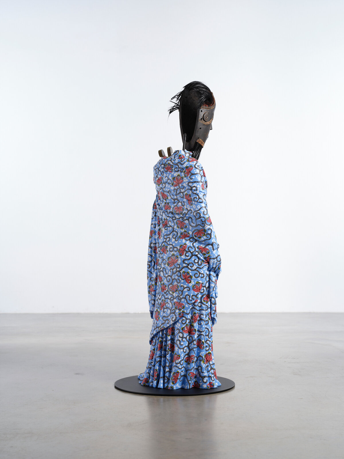 Artwork by Yinka Shonibare, Hybrid Sculpture (Terpsichore / Bété-Guro Mask), Made of Fibreglass sculpture, hand-painted with Dutch wax pattern, hand-carved wooden mask and steel baseplate or plinth 