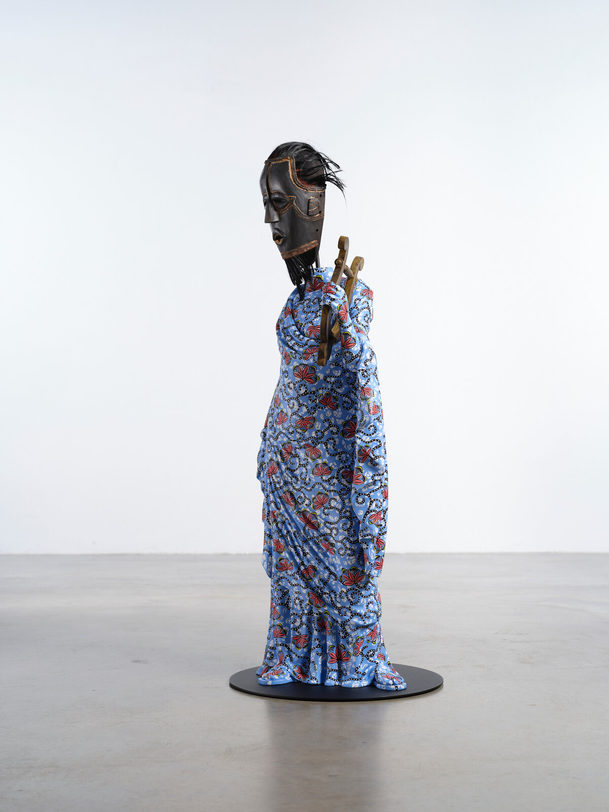 Artwork by Yinka Shonibare, Hybrid Sculpture (Terpsichore / Bété-Guro Mask), Made of Fibreglass sculpture, hand-painted with Dutch wax pattern, hand-carved wooden mask and steel baseplate or plinth 