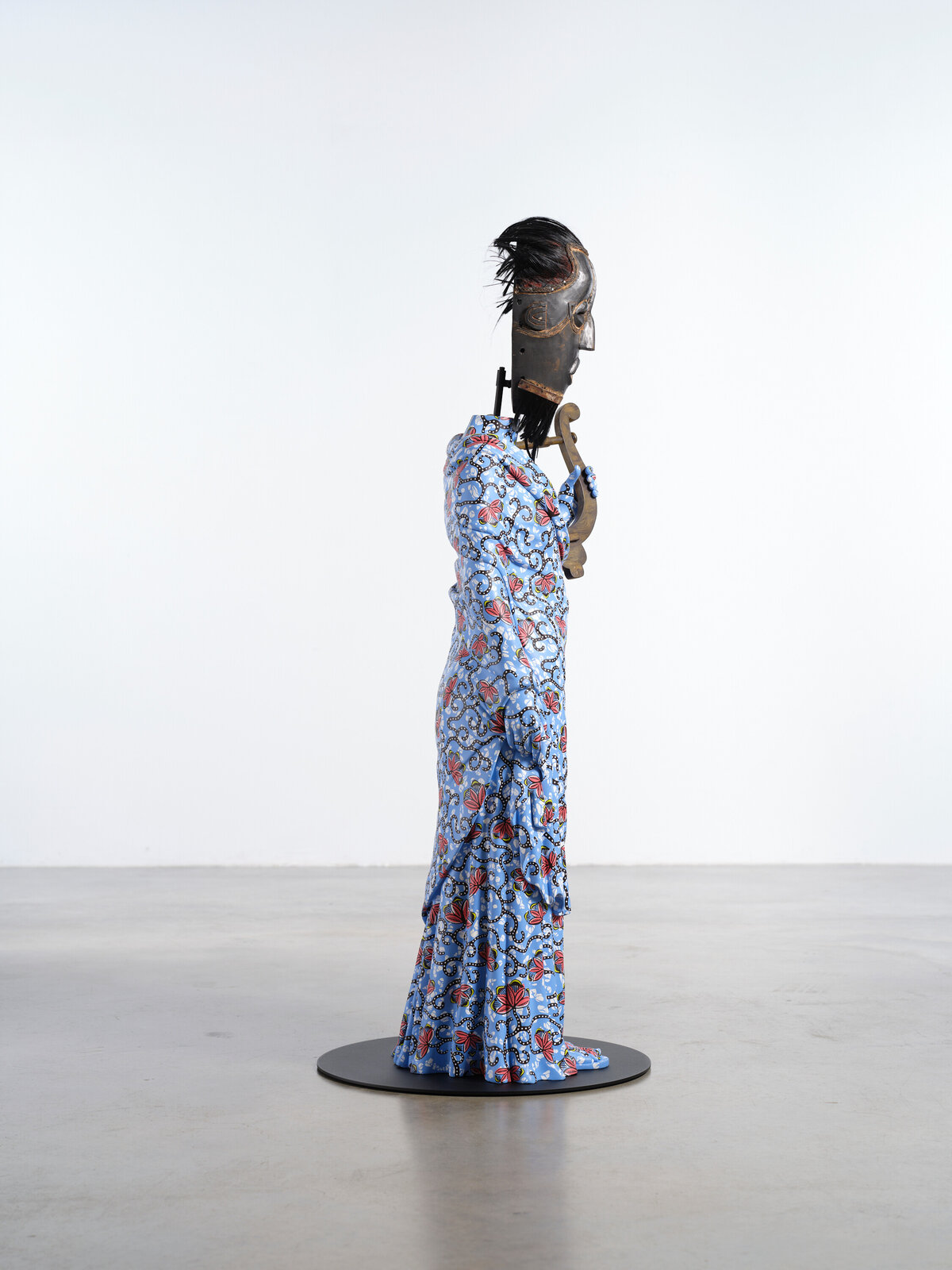 Artwork by Yinka Shonibare, Hybrid Sculpture (Terpsichore / Bété-Guro Mask), Made of Fibreglass sculpture, hand-painted with Dutch wax pattern, hand-carved wooden mask and steel baseplate or plinth 