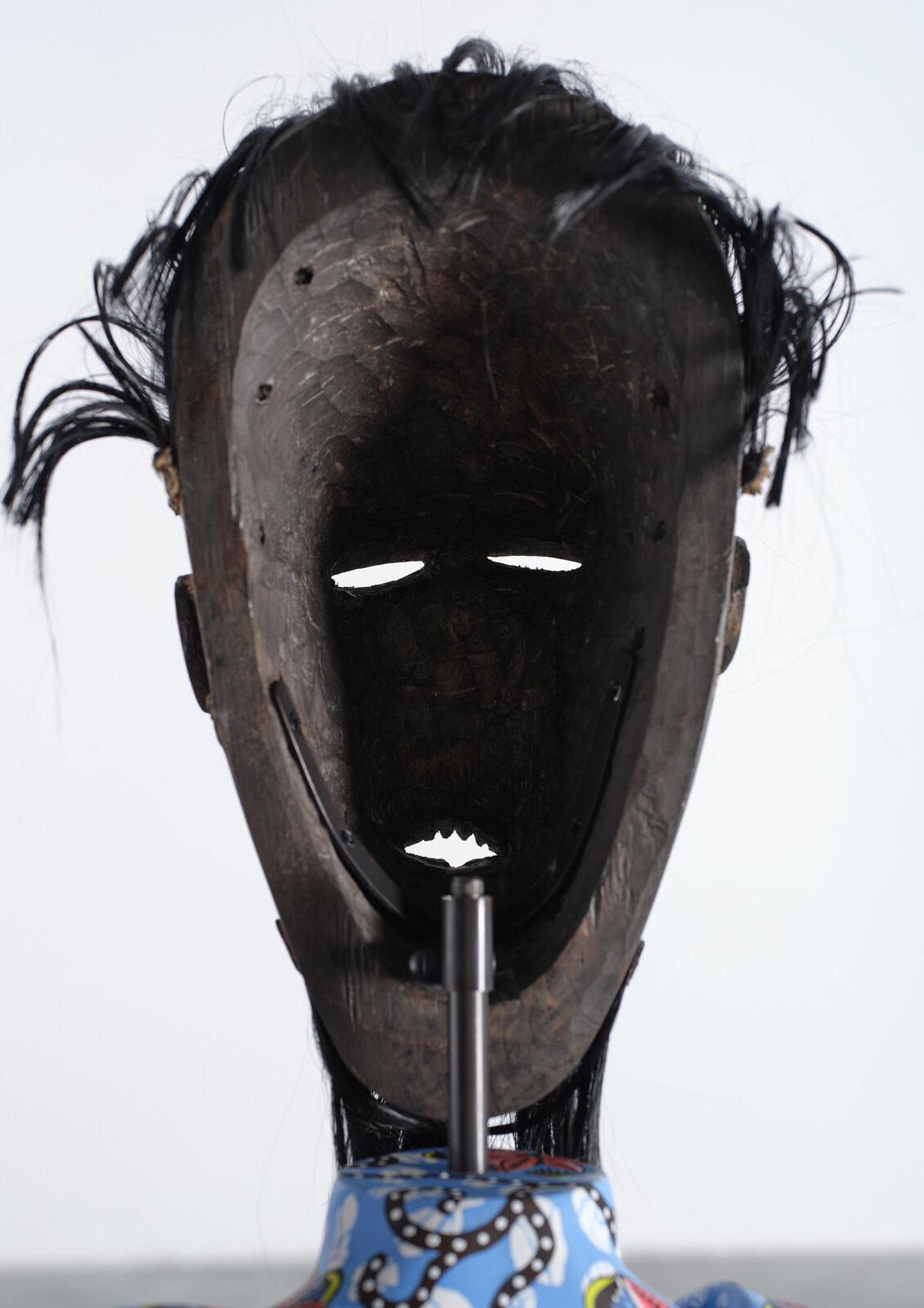 Artwork by Yinka Shonibare, Hybrid Sculpture (Terpsichore / Bété-Guro Mask), Made of Fibreglass sculpture, hand-painted with Dutch wax pattern, hand-carved wooden mask and steel baseplate or plinth 