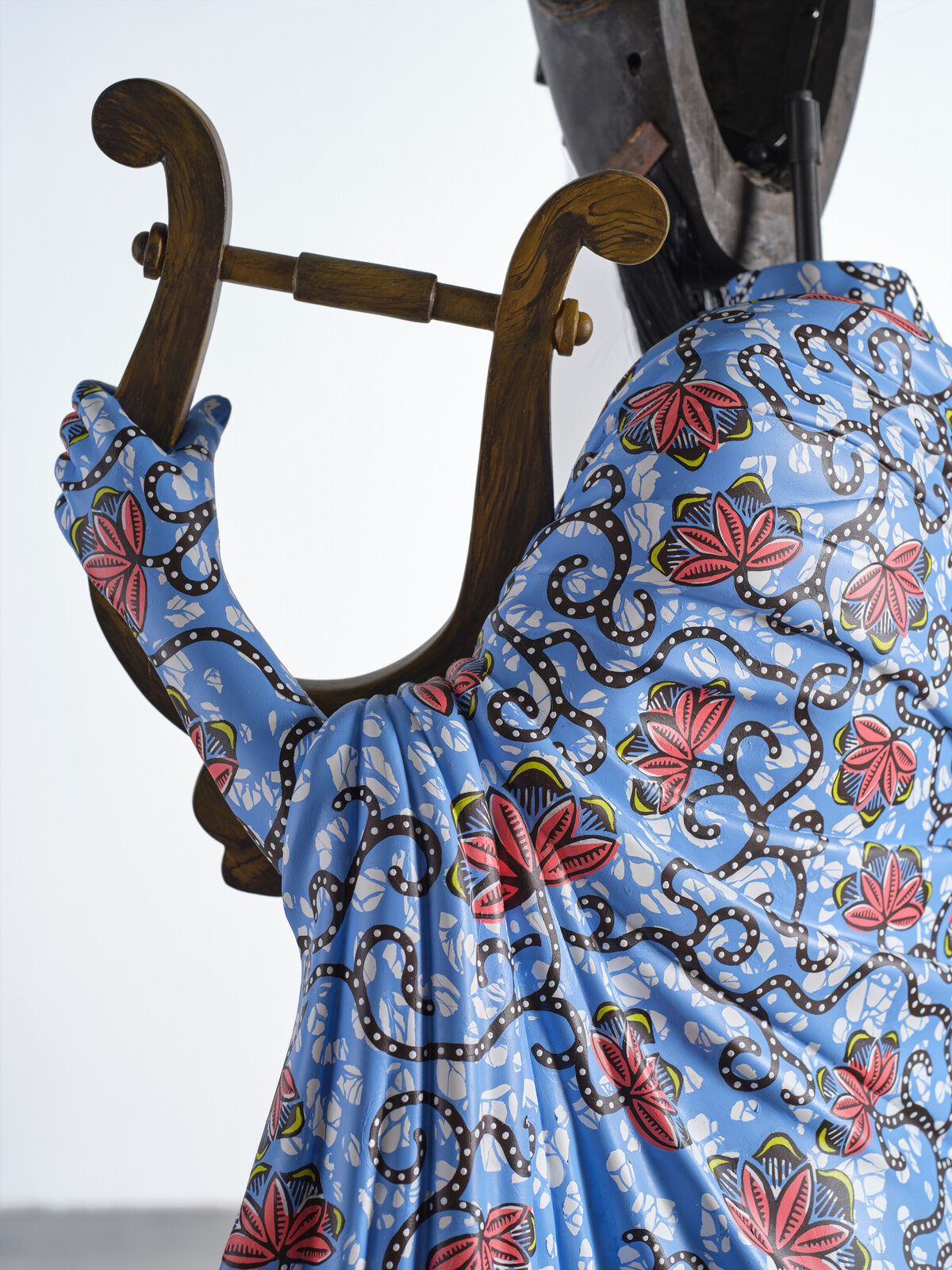 Artwork by Yinka Shonibare, Hybrid Sculpture (Terpsichore / Bété-Guro Mask), Made of Fibreglass sculpture, hand-painted with Dutch wax pattern, hand-carved wooden mask and steel baseplate or plinth 