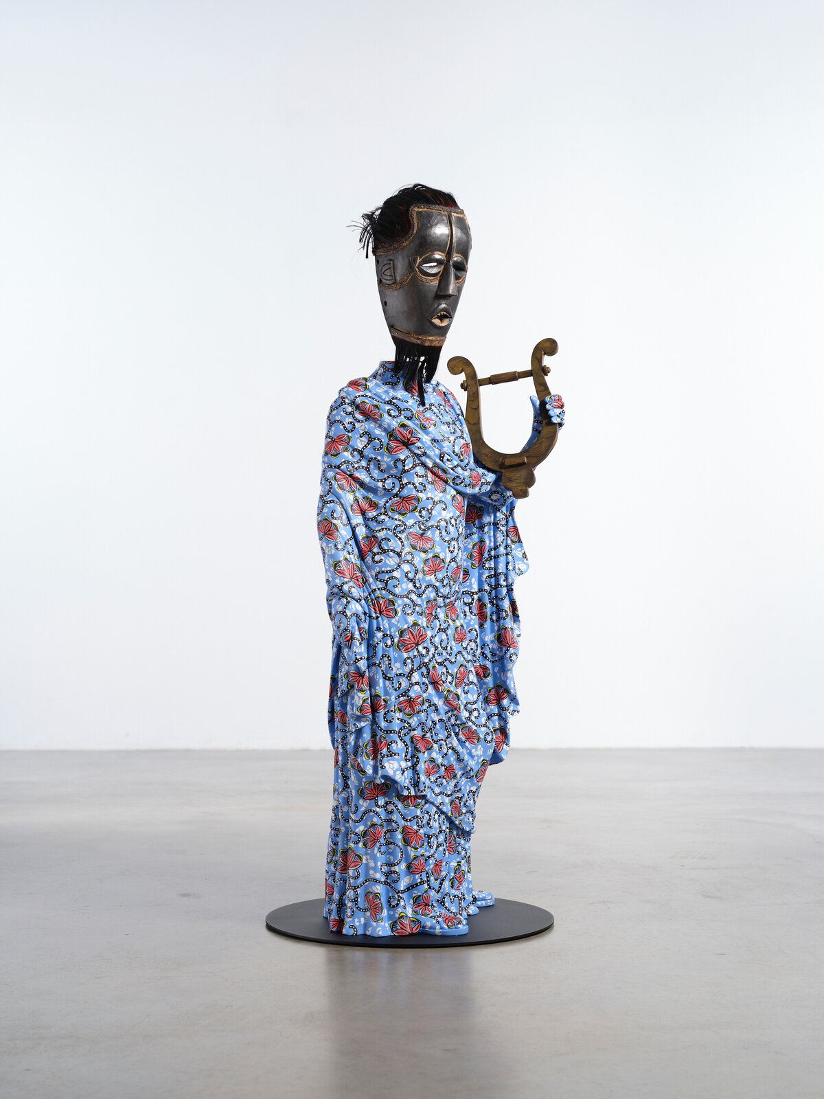 Artwork by Yinka Shonibare, Hybrid Sculpture (Terpsichore / Bété-Guro Mask), Made of Fibreglass sculpture, hand-painted with Dutch wax pattern, hand-carved wooden mask and steel baseplate or plinth 