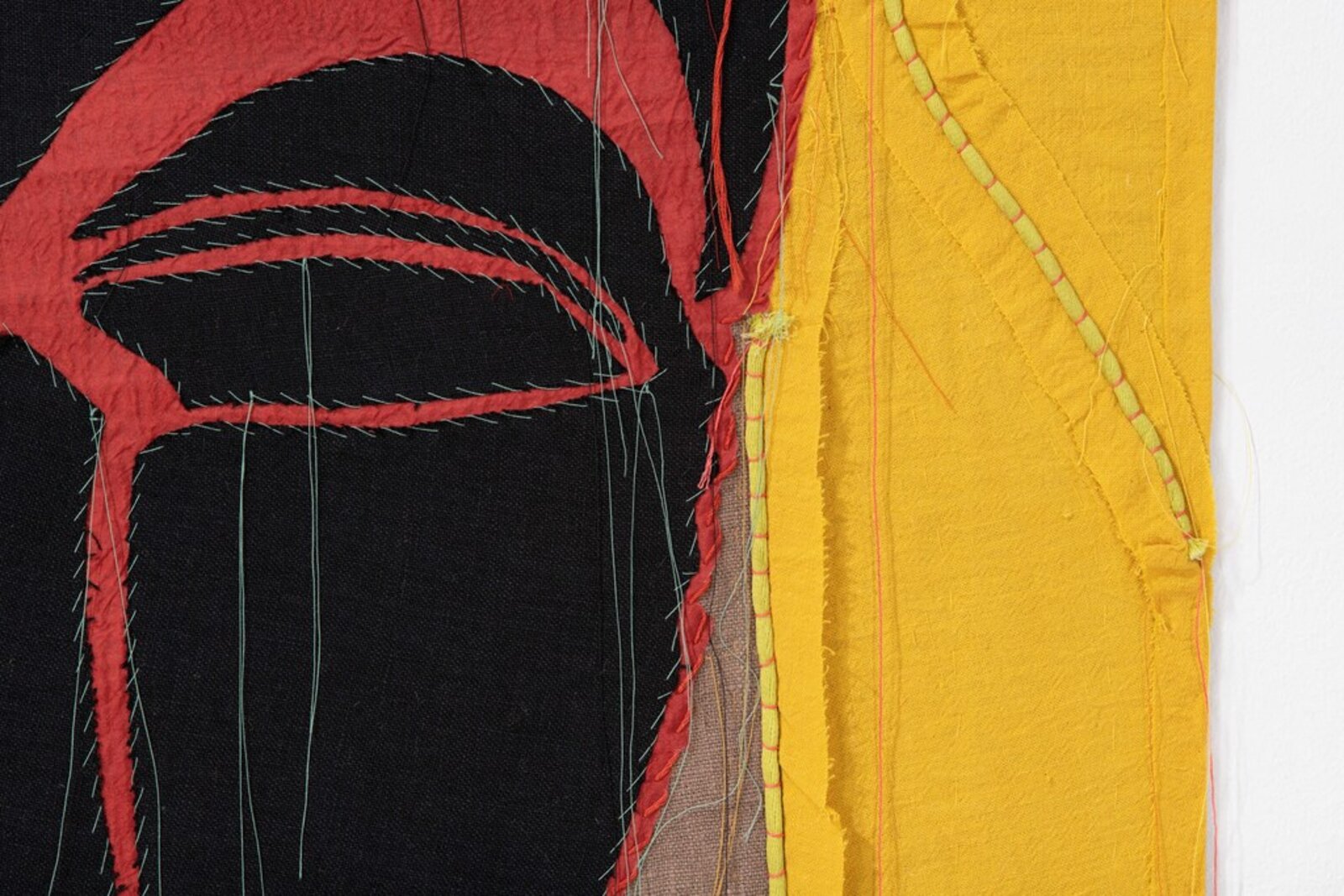 A painting of three masks on a yellow background.