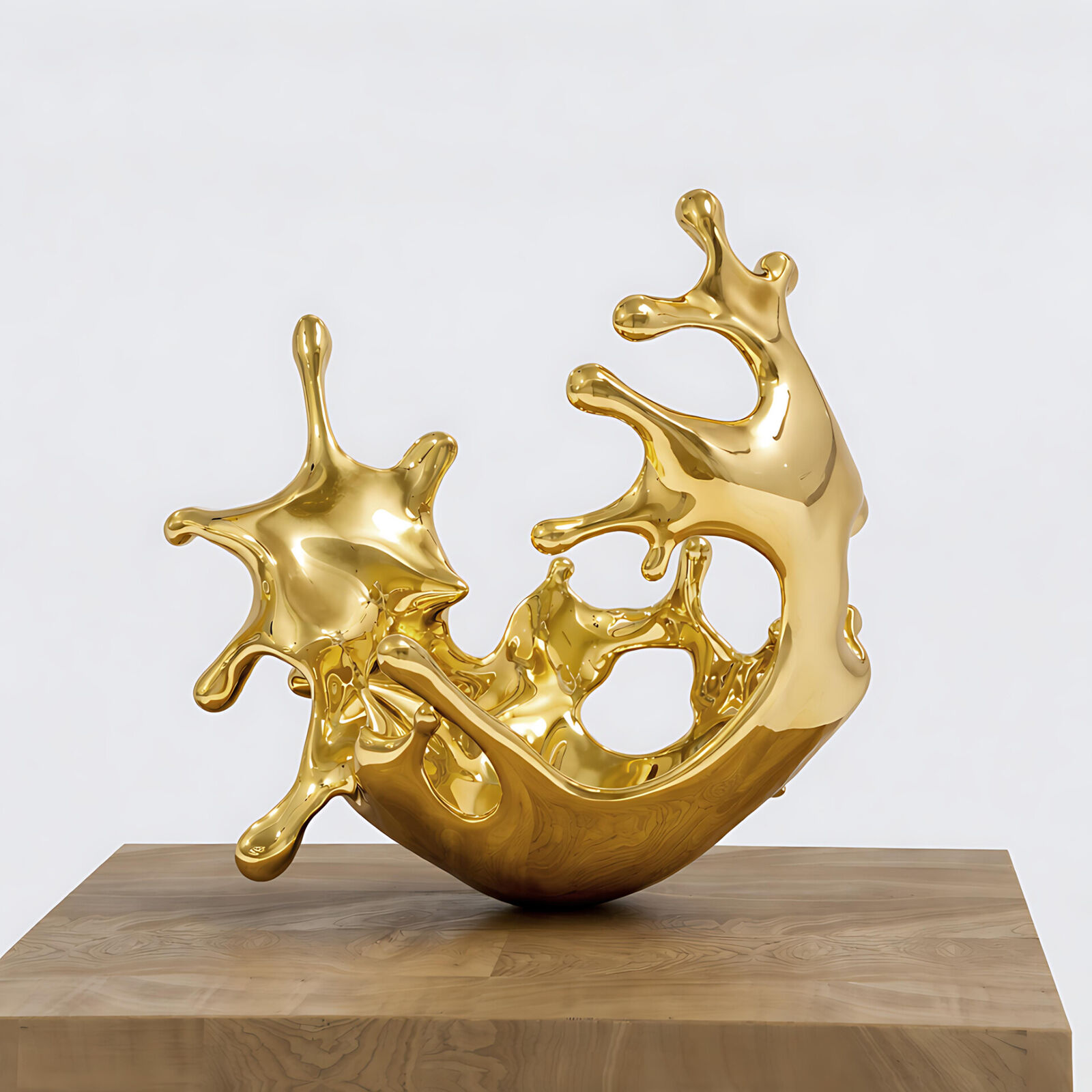 A gold sculpture on a wooden pedestal on a white background.
