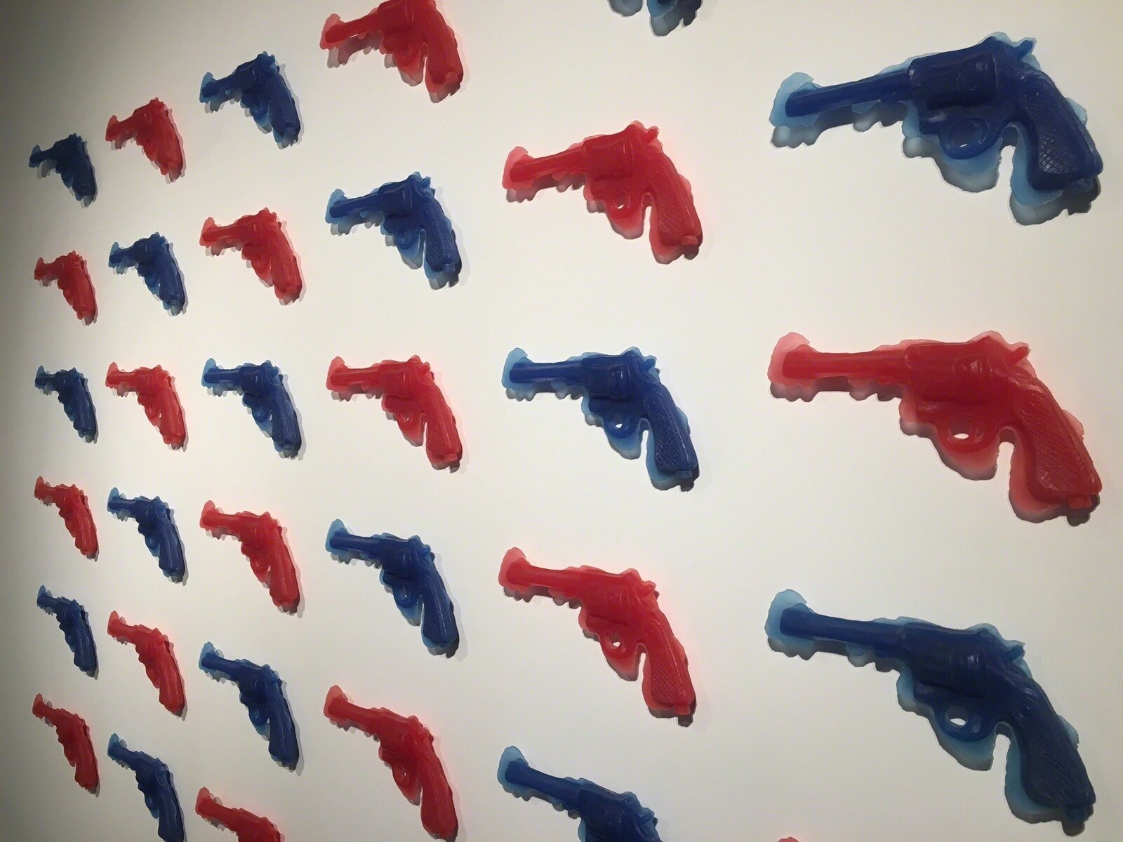 Artwork by Yoram Wolberger, RedGunBlueGun (36 piece installation), Made of Resin cast (36 pieces) 