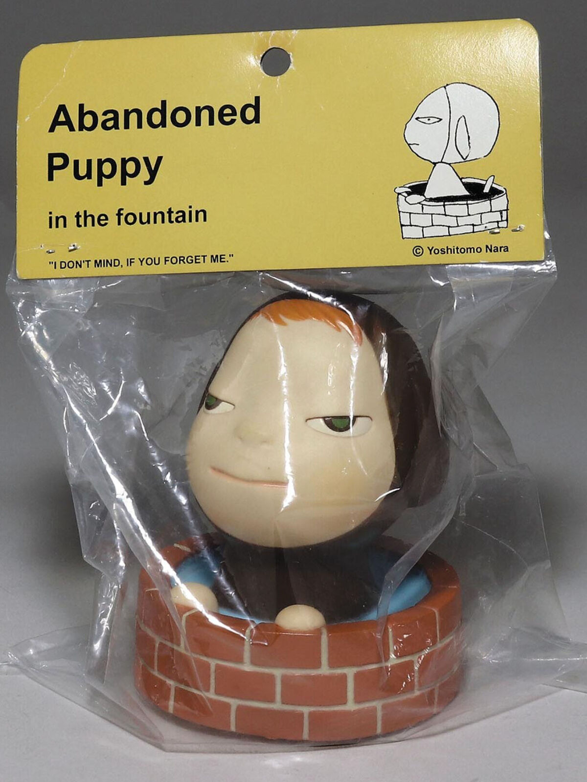 Abandoned puppy in the fountain in a plastic bag.