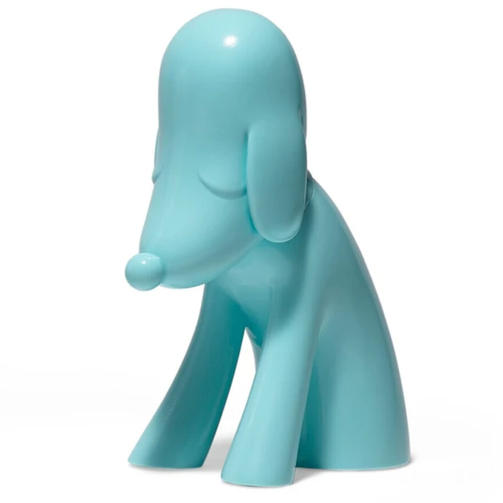 A blue dog figurine sitting on a white surface.