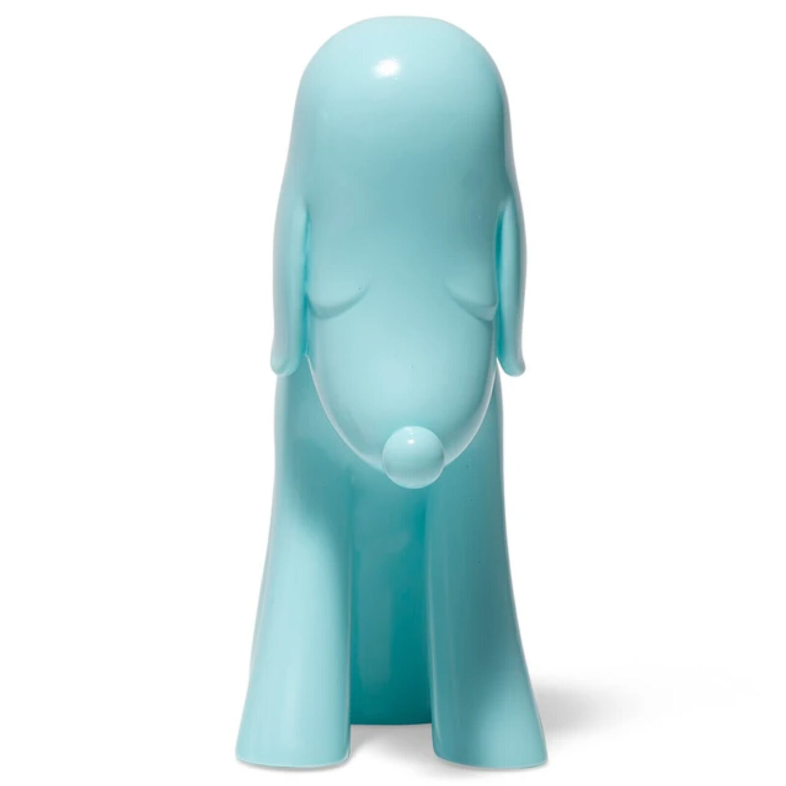 A blue dog figurine sitting on a white surface.
