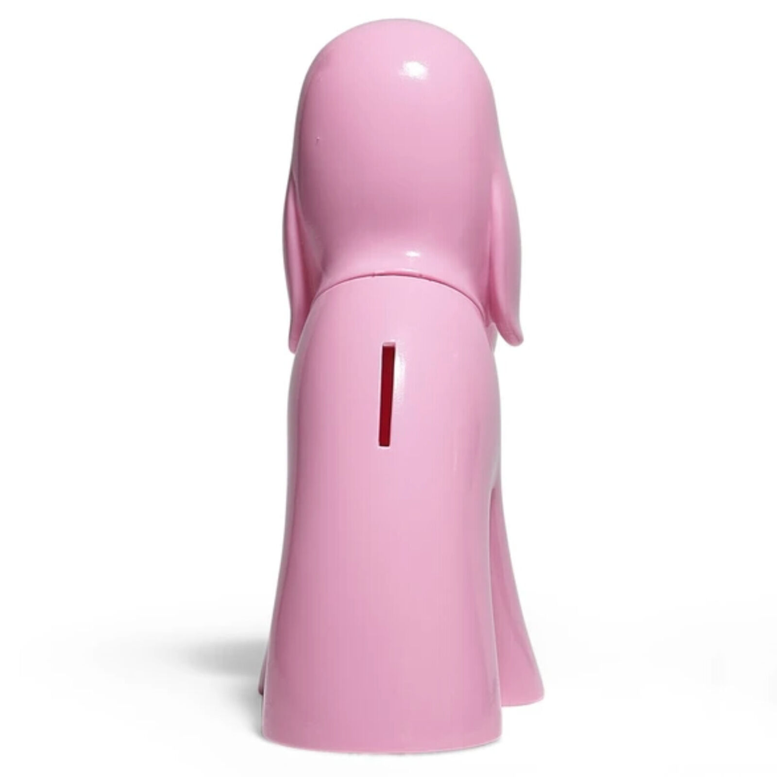 A pink dog figurine sitting on a white surface.