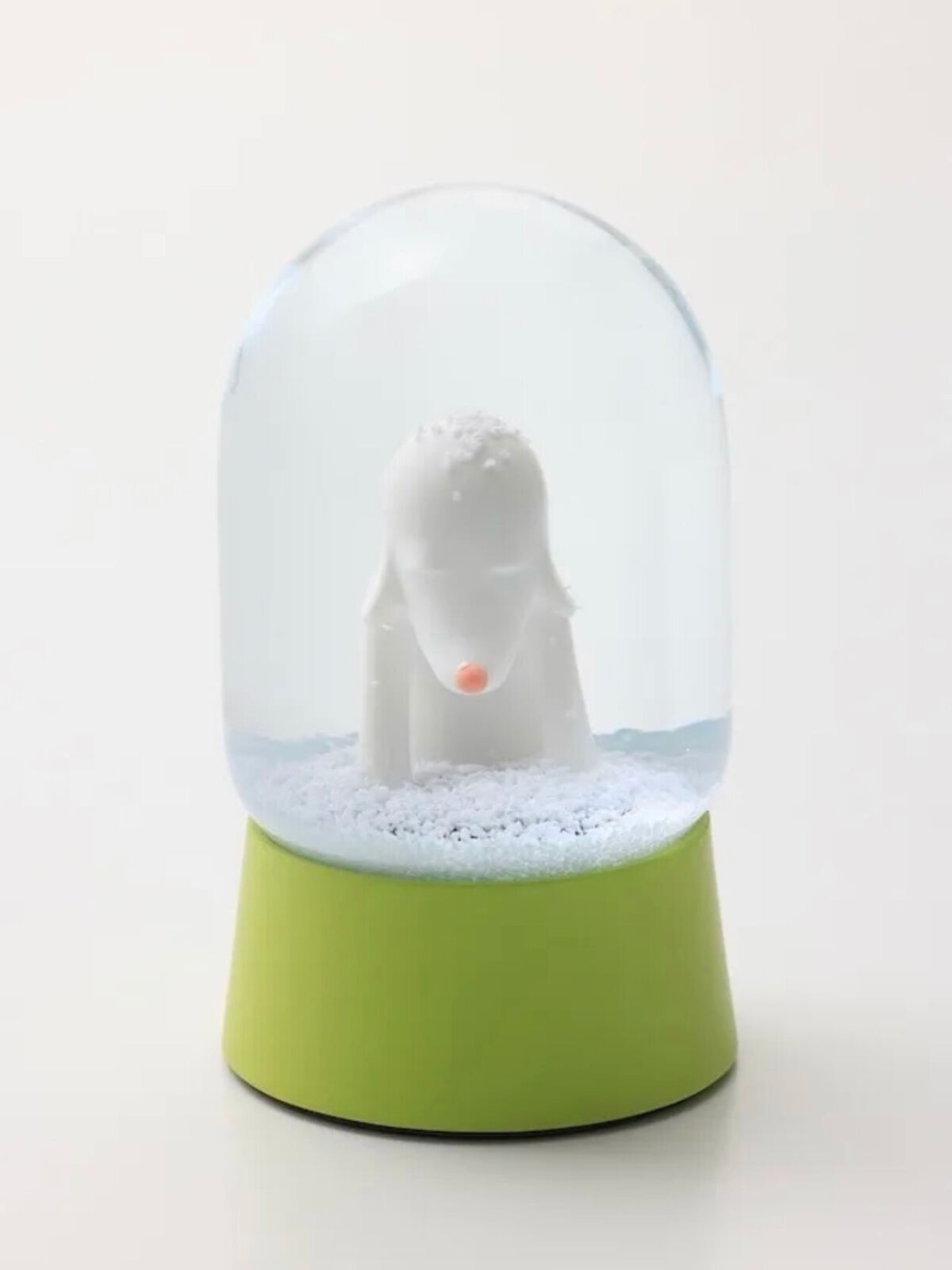 A snow globe with a polar bear inside of it.