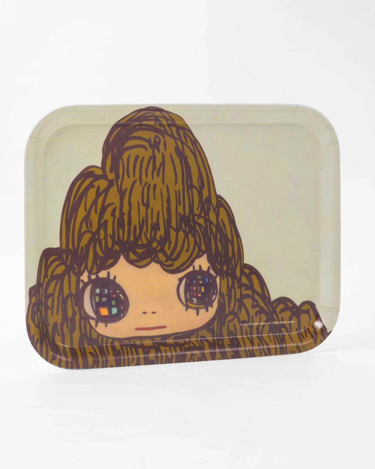 A small tray with a drawing of a girl's face on it.